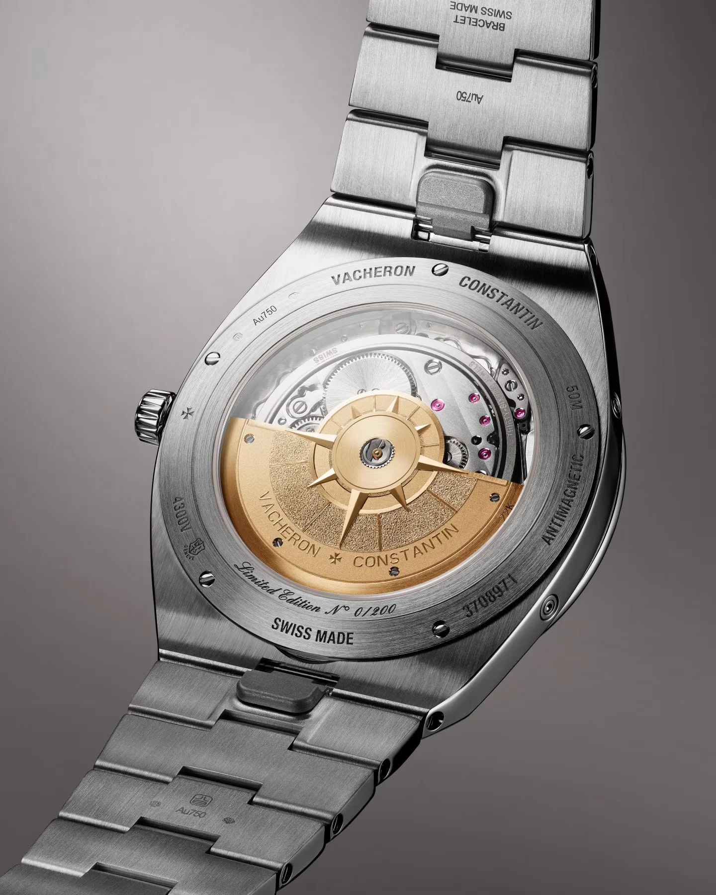 Rear of Vacheron Constantin luxury watch: white gold case & bracelet, gold rotor visible through exhibition caseback, intricate movement.