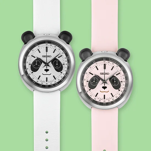Two Seiko panda-face chronographs: white dial/strap on left, pink dial/strap on right. Green and pink background.
