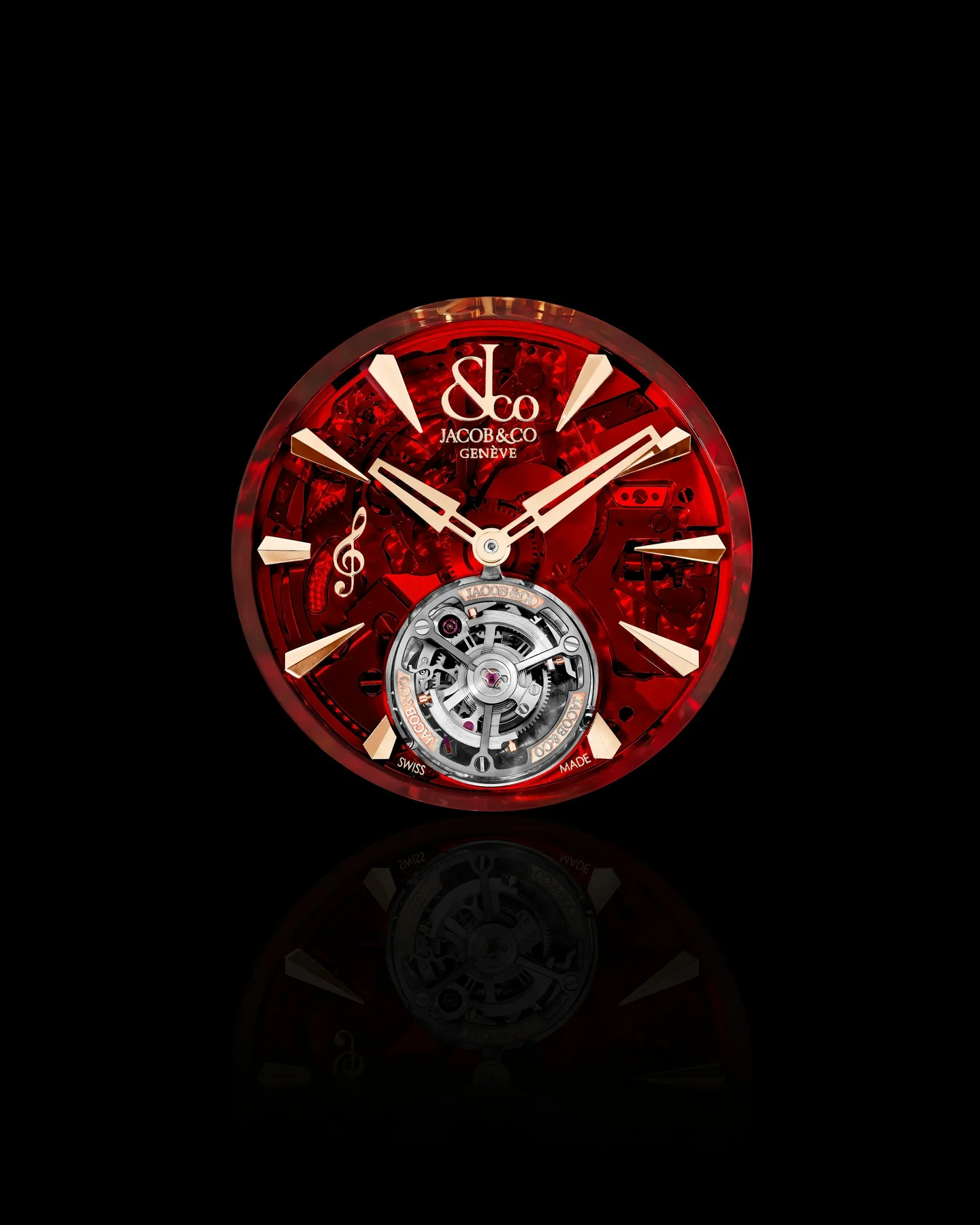 Red Jacob & Co watch with gold accents, visible tourbillon, and treble clef on black, with reflection.