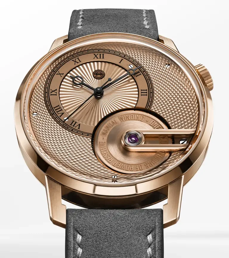 Rose gold luxury watch, intricate guilloché dial with Roman numerals, black hands, power reserve indicator, gray suede strap.