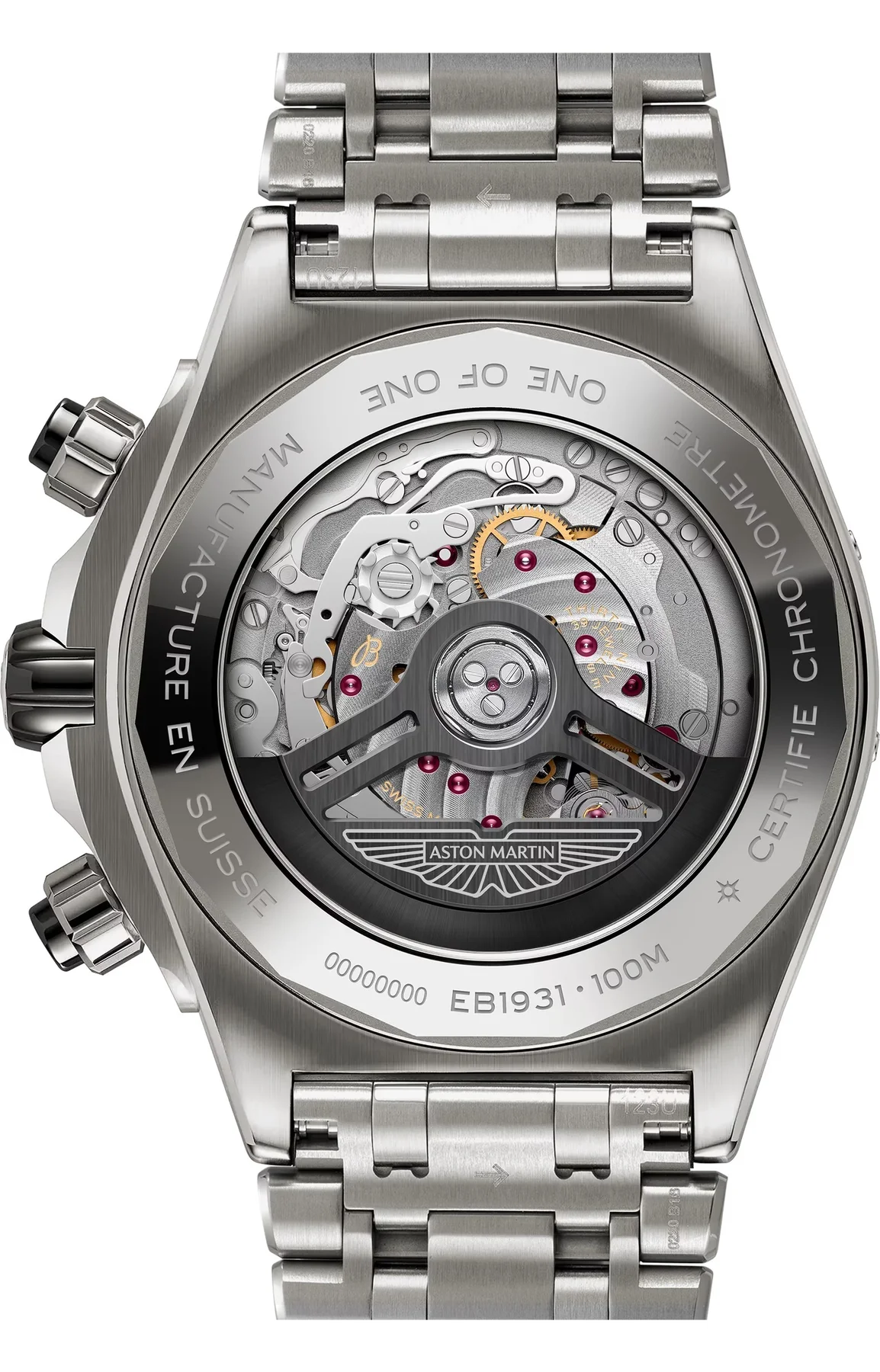 Back of a silver luxury watch with metal bracelet. Exhibition caseback shows automatic movement with red jewels and an Aston Martin rotor.