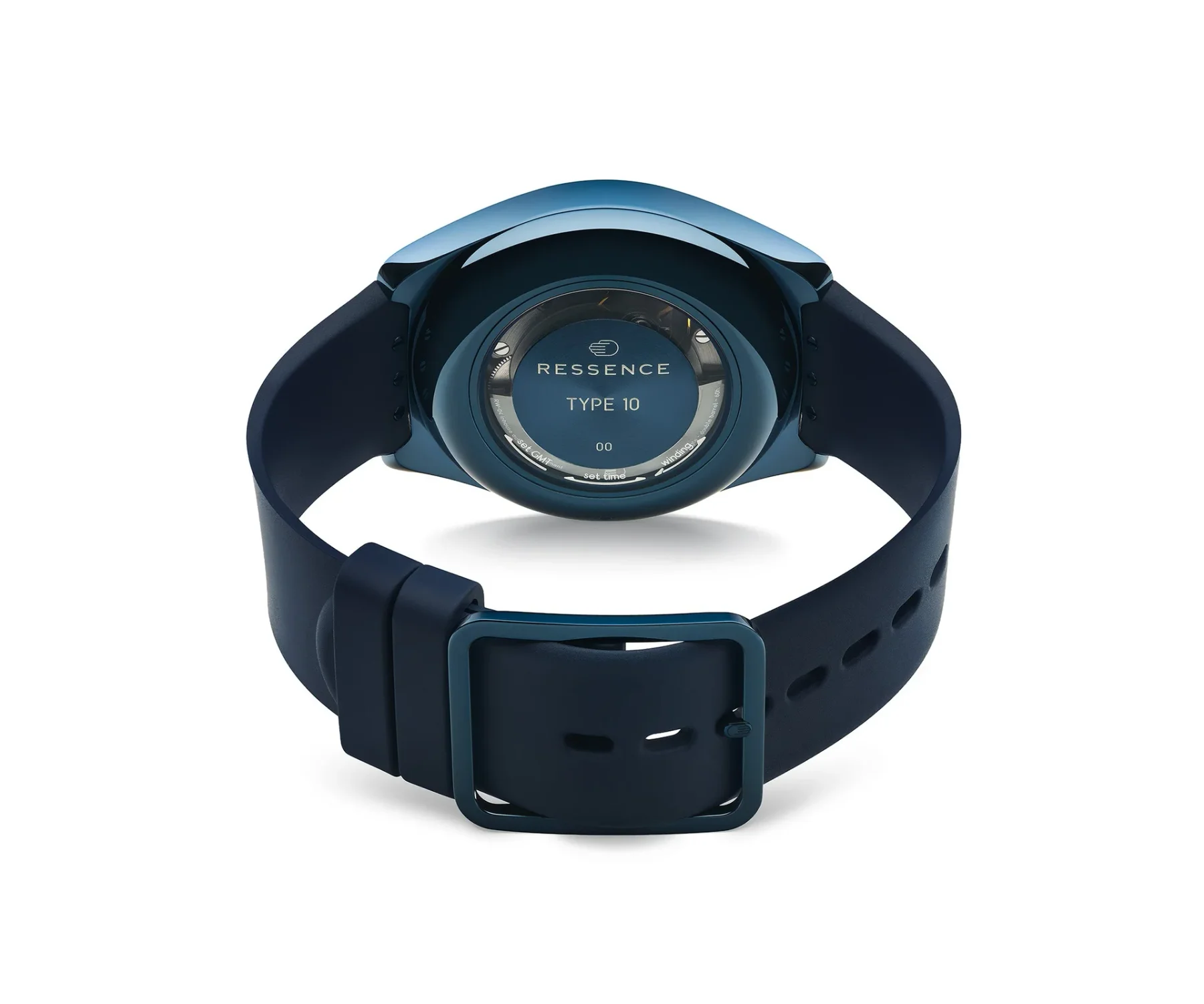 Rear of a blue Ressence Type 10 watch. Circular window on case back displays model name & controls. Blue strap & buckle.