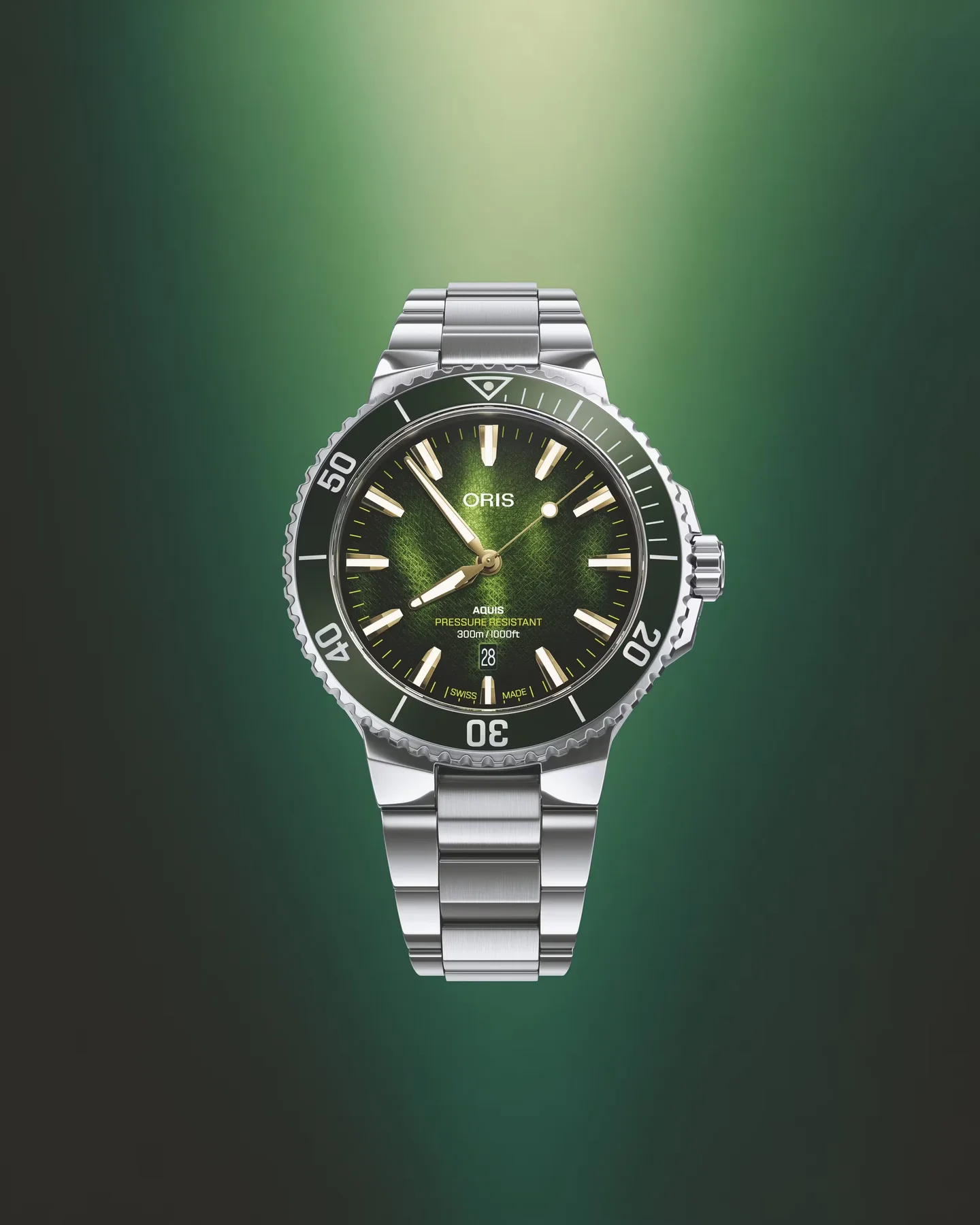 Oris Aquis diver watch with sunburst green dial, green bezel, steel bracelet, date 28, against a green gradient.