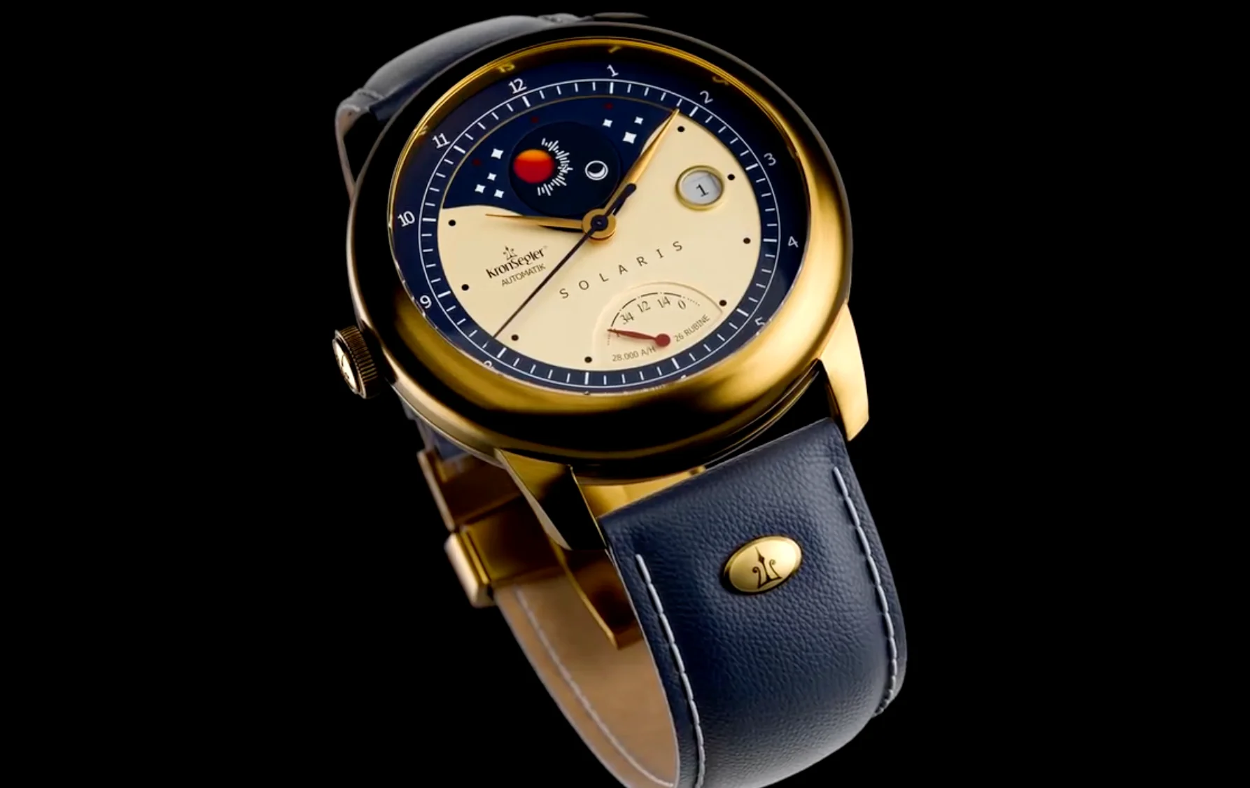 Gold Kronsegler Solaris watch with a blue and cream sun/moon dial, date, power reserve, and blue leather strap.