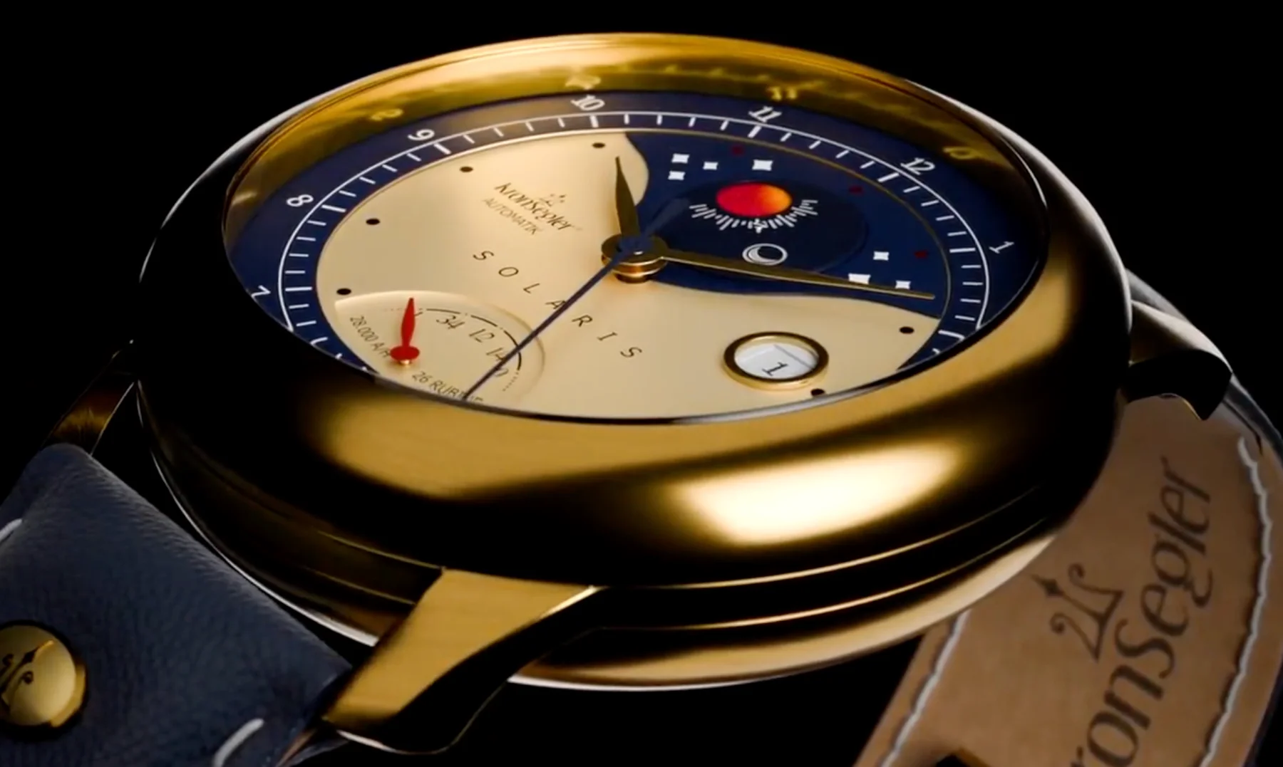 Gold KronSegler Solaris watch with a two-tone gold/blue dial featuring date, power reserve, and day/night. Blue leather strap.