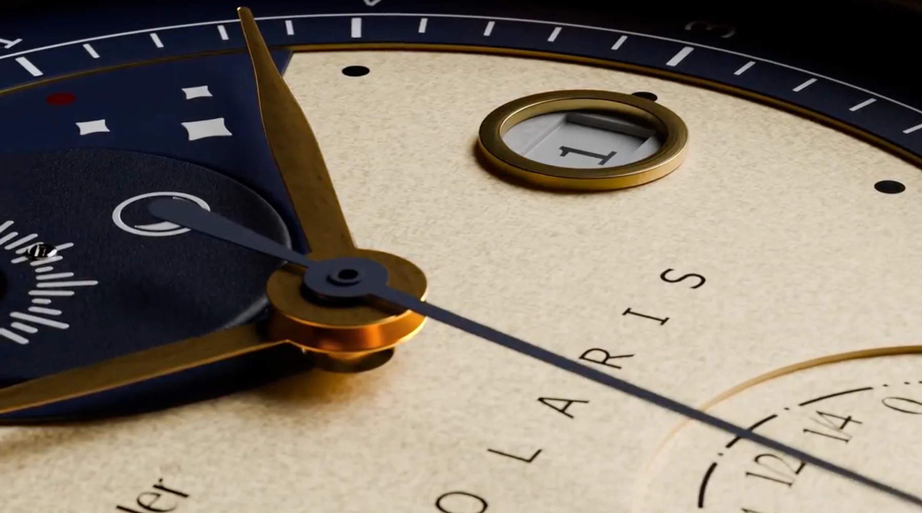 Close-up of a Polaris luxury watch dial. Textured light gold face, gold hands, blue sub-dials, date window shows "1".