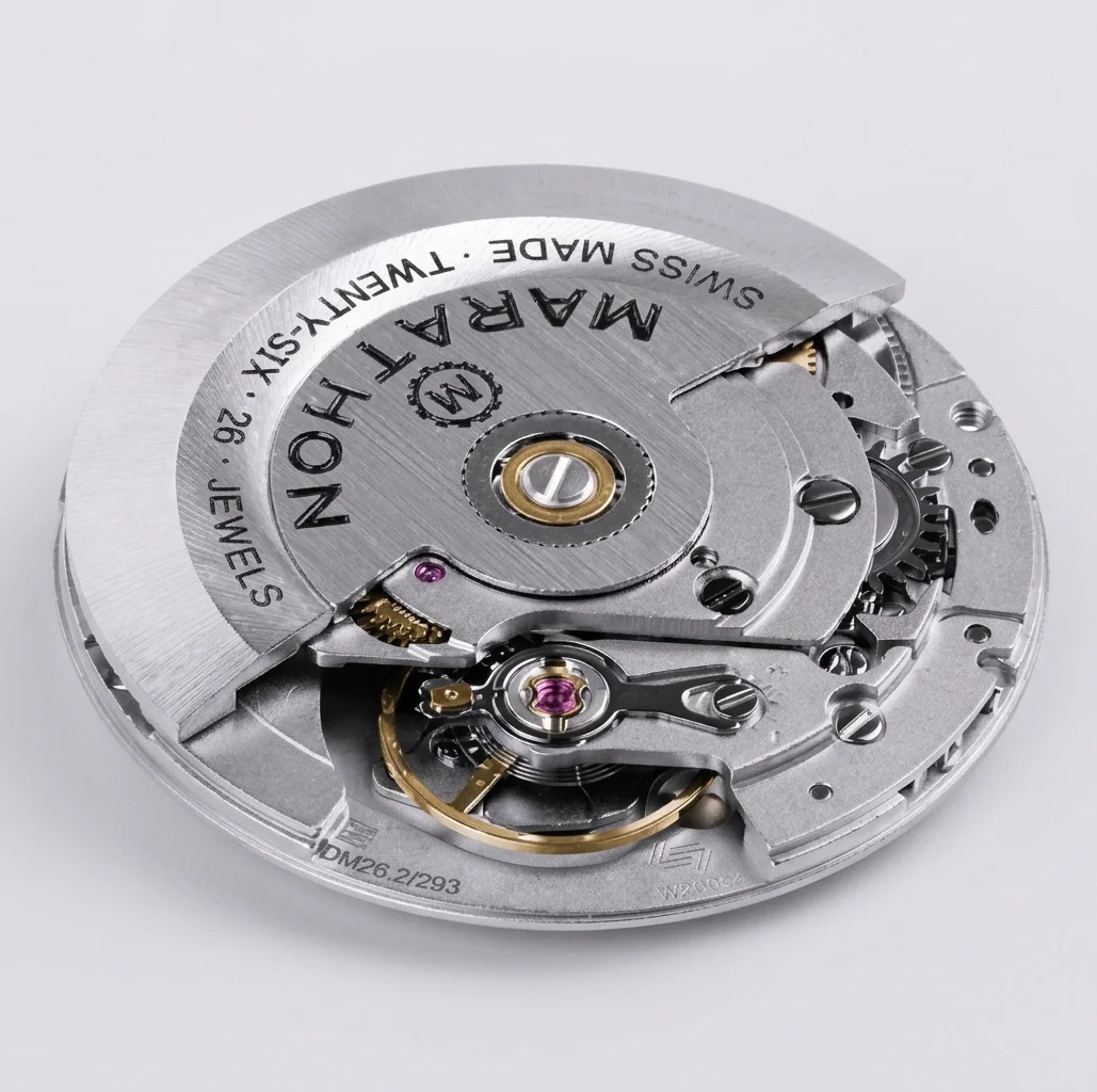 Marathon automatic watch movement showing brushed rotor, visible gears, ruby jewels, and 'Swiss Made 26 Jewels'.