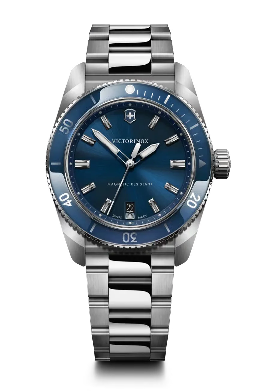 Victorinox dive watch with a sunray blue dial, glossy blue bezel, date window, and steel bracelet, on black.