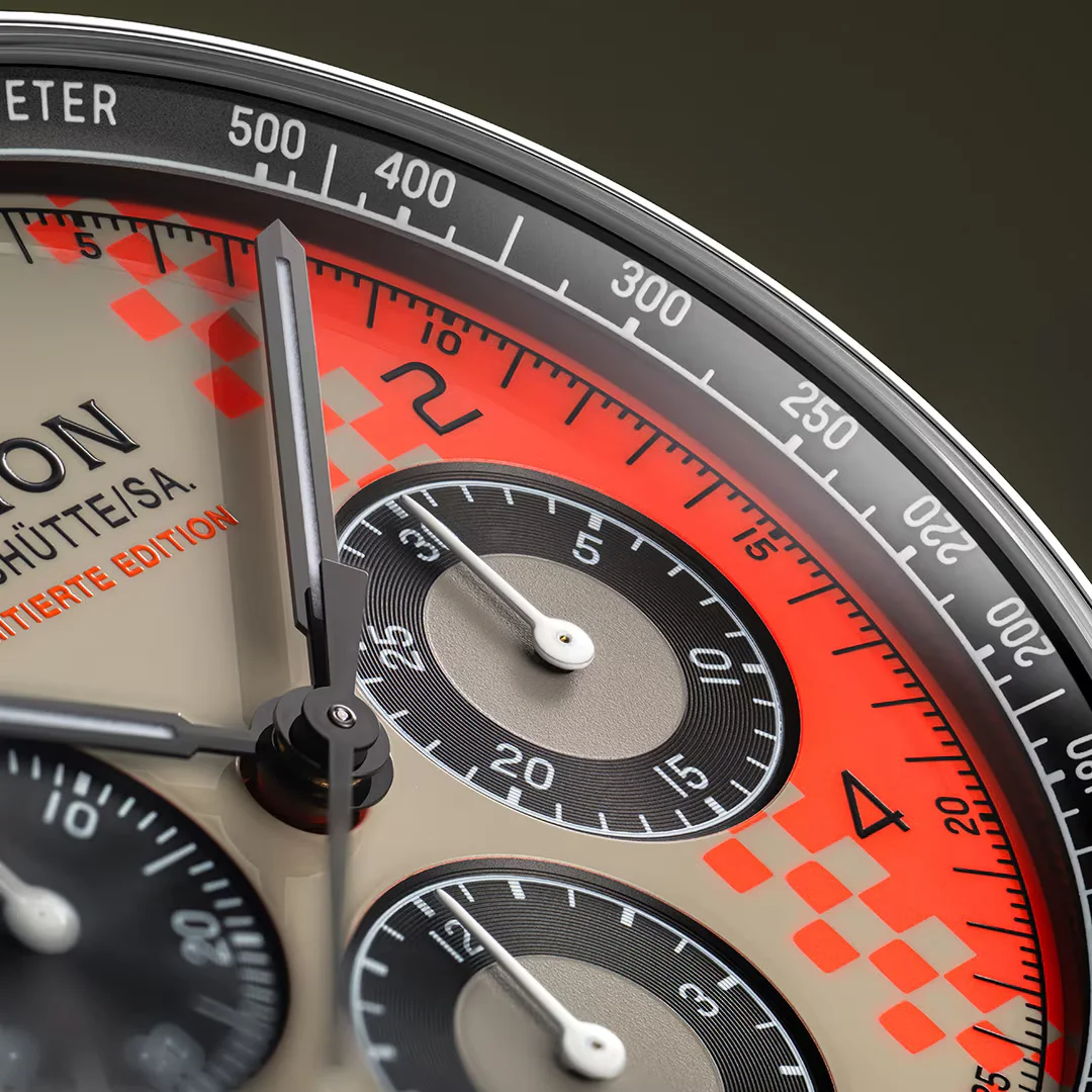 Close-up: Union Glashütte limited edition watch dial. Beige with orange checkered sector, black sub-dials, tachymeter.