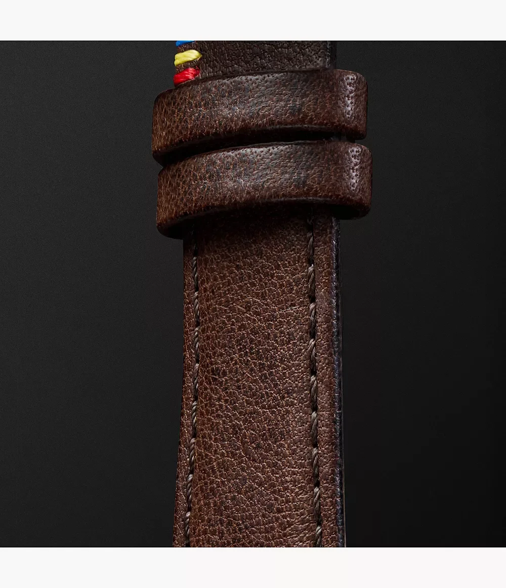 Close-up of a brown leather watch strap with two keepers & multicolored stitching details on a dark background.