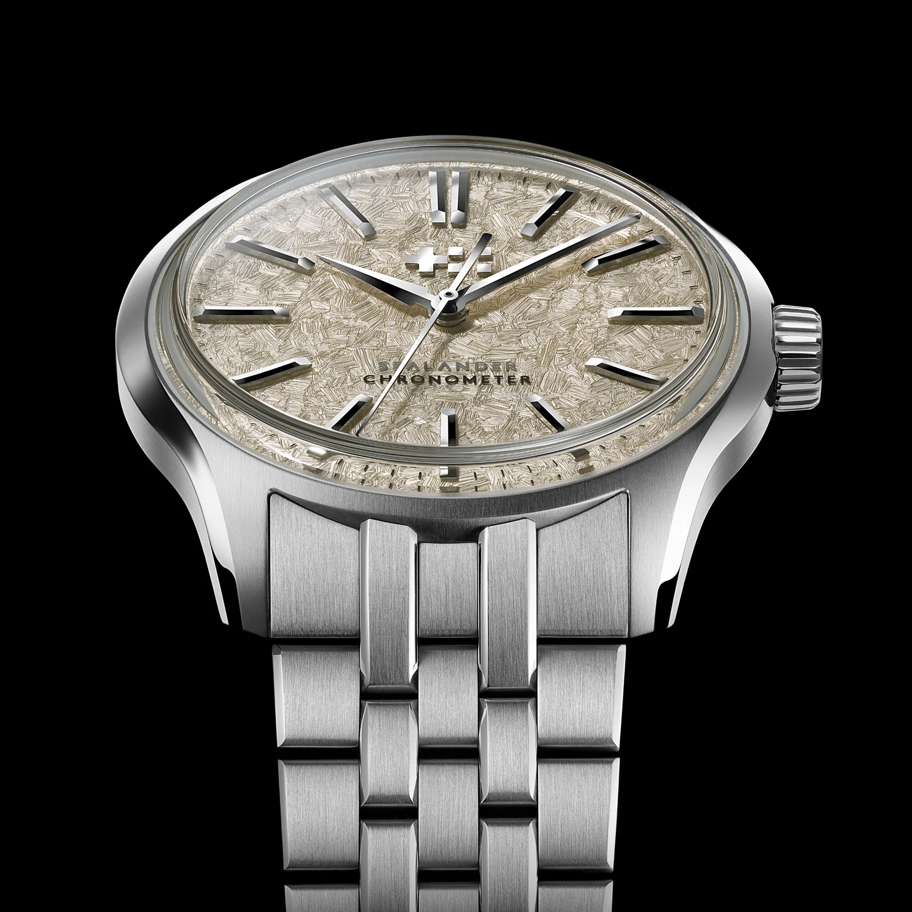 Luxury watch with a brushed steel case, striking crystallized gold-tone dial, polished hands, fluted crown, integrated bracelet.