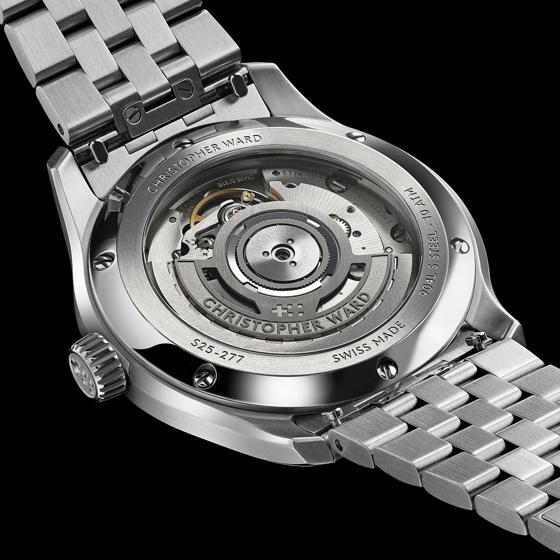 Luxury Christopher Ward watch with transparent case back showing automatic movement. Stainless steel case & bracelet on black.