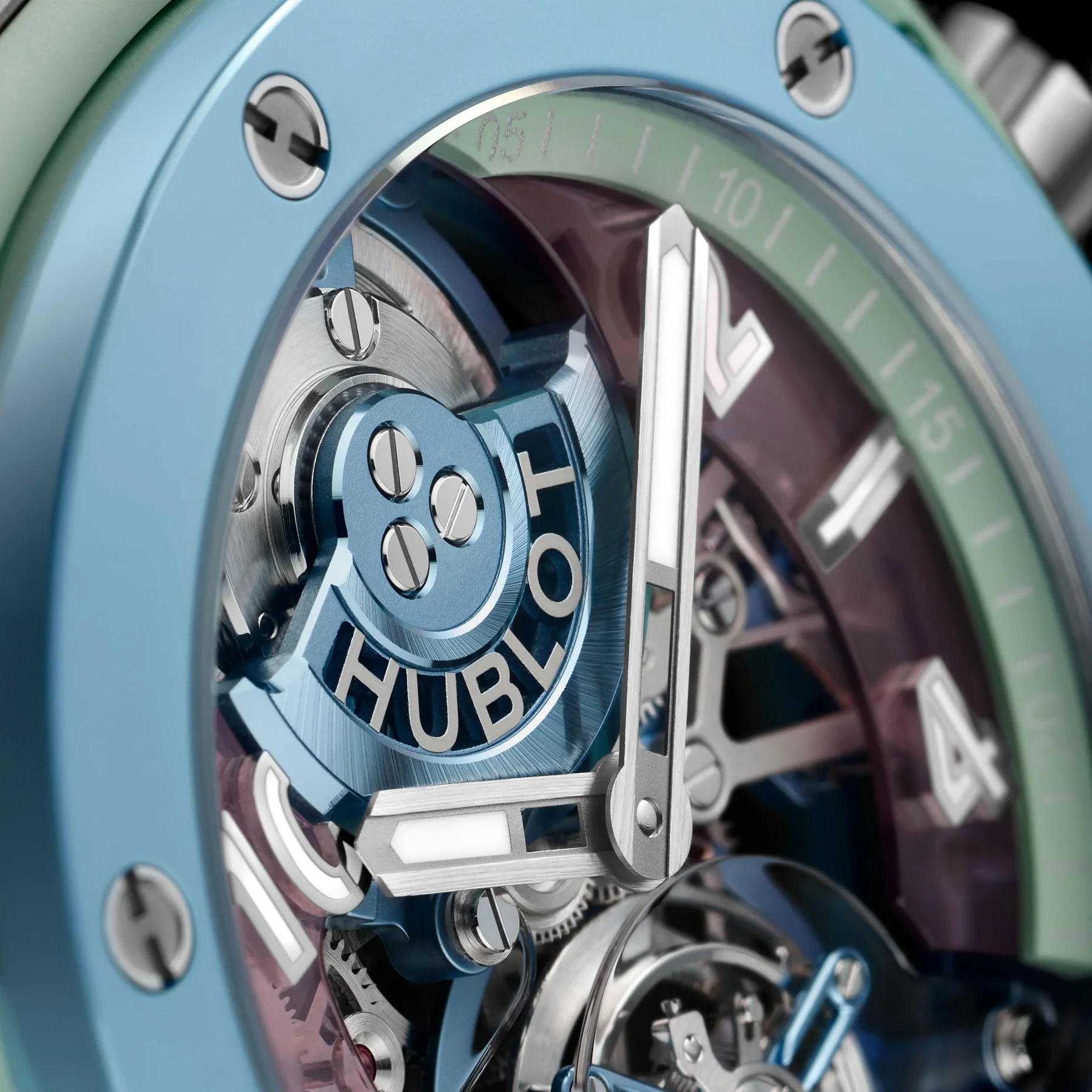 Close-up of a blue & green ceramic Hublot Big Bang Unico Summer watch. Skeleton dial reveals movement, minute markers visible.