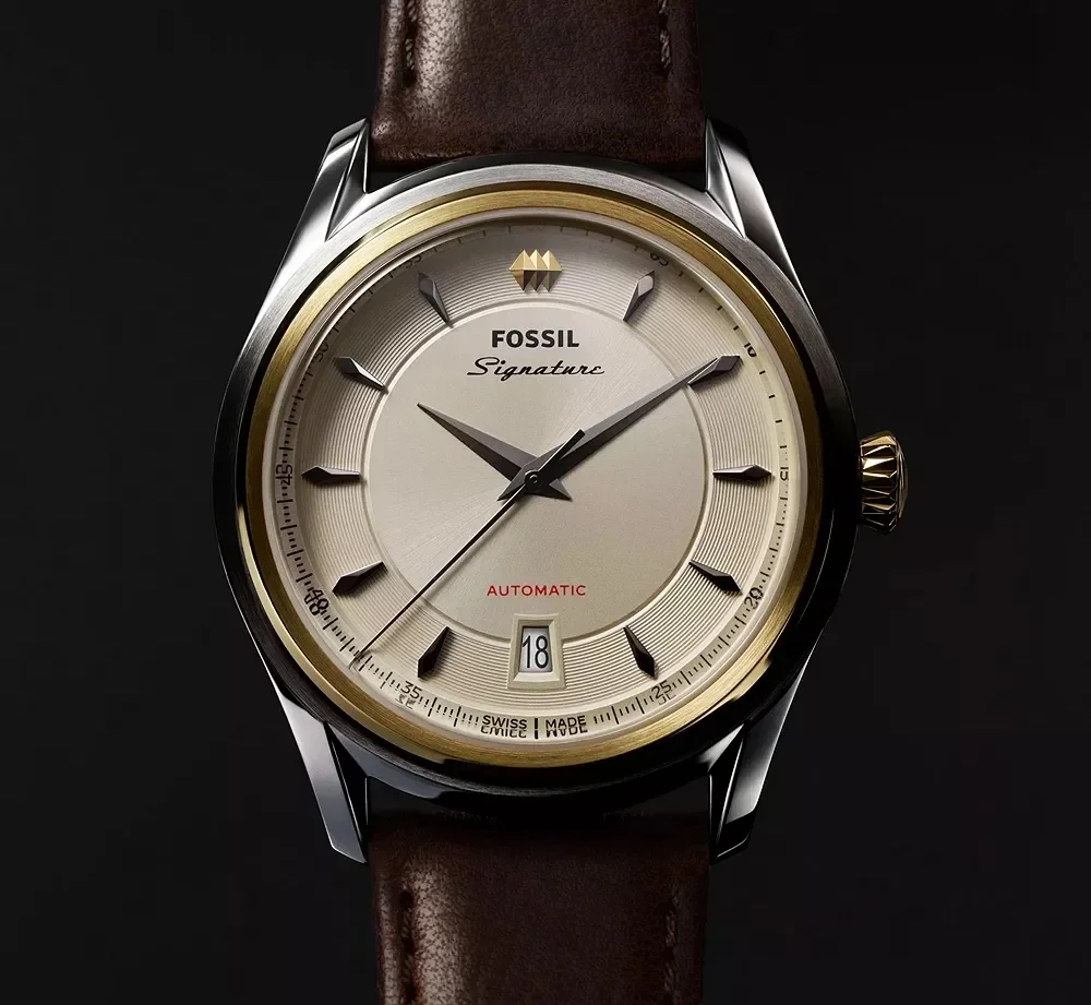 Fossil Signature automatic watch with a champagne dial, gold bezel, silver case, and brown leather strap.