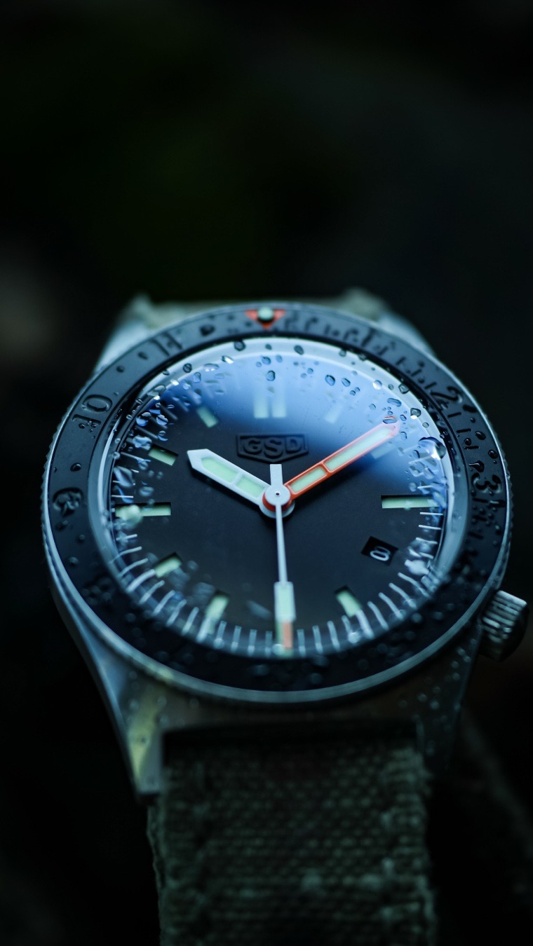 The Greg Stevens Design (GSD) 6 Series diver stands out as an exceptional value at its $595 point, successfully delivering retro-inspired military aesthetics and robust microbrand engineering without the usual high-tier price tag. While many microbrands under $600 cut corners by using lower-beat movements or standard “catalog” cases, Greg Stevens pairs premium, high-utility specifications with uncompromised, strap-first wearability.

Finding a true, 300-meter mechanical dive watch with premium components for under $600 is remarkably rare. The GSD 6 Series packs incredible utility into its sub-$600 MSRP:
* Powered by the Miyota 9015 automatic movement. This high-beat caliber operates at 28,800 vibrations per hour, offering a premium, smooth-sweeping seconds hand usually reserved for much pricier watches.
* Features a highly legible sandwich dial with C3 Superluminova protected by a scratch-resistant, vintage-style boxed sapphire crystal.
* Features a practical 12-hour bezel allowing the user to seamlessly track a second time zone without the added cost or complexity of a true GMT movement.
*  Delivers 300m of water resistance while remaining incredibly slim at just 12.7mm thick, ensuring it sits flat on the wrist.

Where the 6 Series completely blows past its competition is the standard bundle included in the box. Because Greg is an acclaimed, master custom strap maker first, he engineers his watch heads to look spectacular on heavy-duty, high-end footwear.
Instead of forcing you to purchase a quality strap separately, every 6 Series watch ships as a complete, multi-strap system:
1. A premium custom GSD strap of your choice (crafted from elite materials like Horween leather or heavy vintage canvas)
2. A heavy-duty nylon strap
3. A solid stainless steel bracelet
Given that a standalone, handcrafted custom leather strap from Greg Stevens can easily cost $150 or more on its own, getting one tailored directly to your watch—alongside two other hardware options—makes the $595 price tag an absolute steal. It is a complete, ready-for-anything watch kit that outclasses everything else in its price bracket.
#watchporn #fielddiver #watchlover #watchobsession #watch