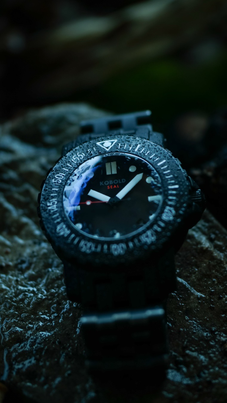 The Kobold Tactical Seal is not a luxury accessory masquerading as a diver. It is an aggressively over-engineered, uncompromising wrist vault built specifically for high-impact tactical operations, remote exploration, and saturation deep-sea diving.
While mainstream brands rely on flashy marketing gimmicks, Kobold earned its iconic reputation among military specialists and hardcore enthusiasts by letting the engineering speak for itself.
Here is exactly why the Tactical Seal stands as a masterclass in dedicated tool watch design.
Redundant Dual Shock Absorption
Most mechanical watches rely solely on a standard, internal movement-level shock absorber like the Incabloc system. The Tactical Seal doubles down on protection by pairing that standard assembly with Kobold’s patented Shock Absorption System (SAS). The SAS is integrated directly into the case-wall architecture, mechanically isolating the Swiss automatic core. This dual-protection barrier cushions the movement against severe concussive impacts, extreme vibrations, and weapon recoil.
Soft Iron Anti-Magnetic Cage
Powerful magnetic fields can freeze or permanently degrade the accuracy of a mechanical timepiece. To prevent this, the Tactical Seal features a secondary internal shield made of soft iron that completely surrounds the Swiss automatic mechanism. This inner cage functions as a Faraday shield, safely deflecting intense electromagnetic interference from tactical machinery, communication gear, and specialized deep-sea equipment.
The Kobold Tactical Seal remains an anti-establishment badge of honor for horological purists. Because production runs have historically been kept incredibly minimal—often capped at a mere handful of pieces per year—it stands as a rare, bulletproof instrument that chooses absolute utilitarian purpose over mass-produced luxury. It is built not to be babied, but to survive the absolute worst conditions on earth.