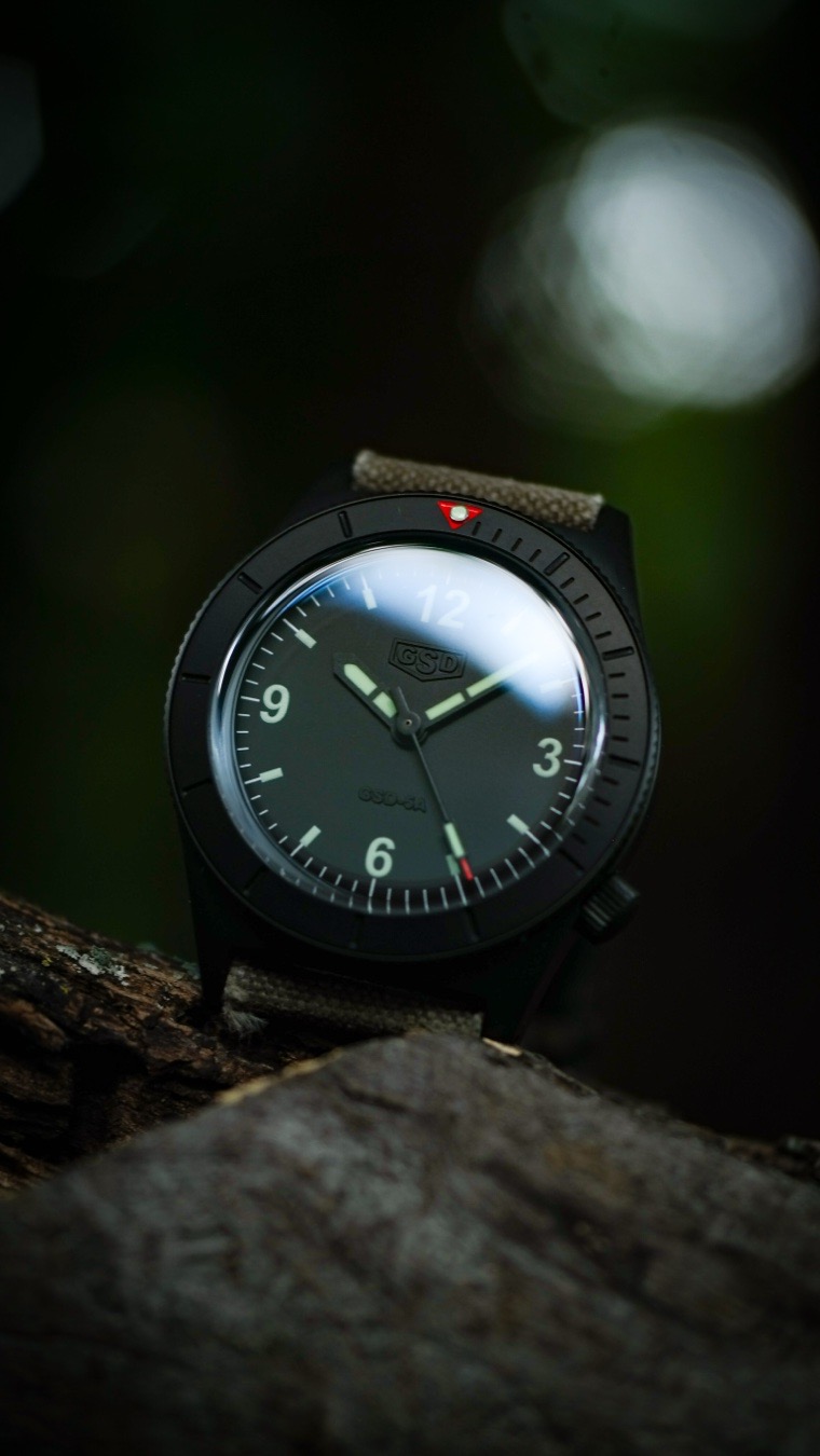 While many catalog-built microbrands focus on hype, spec sheets, and colorful mass appeal, the Greg Stevens Design (GSD) 5 Series PVD takes a completely different path. Built with an uncompromising “workshop piece” mentality, it offers unique advantages that elevate it over mainstream sub-$1,000 choices.
Here is why the GSD 5 Series PVD stands apart as the superior choice against watches like the Nodus Sector Deep, Traska Venturer GMT, RZE Aspirate, Zelos Spearfish, Baltic Aquascaphe MK 2, Lorier Falcon. 

Many brands in the sub-$1,000 category compromise on movement costs to fit their budgets, often utilizing Japanese Miyota or Seiko calibers (such as those found inside Traska, Baltic, or Nodus models). The GSD 5 Series is powered by the Swiss Sellita SW200-1.

Mass-market watches often clutter their dials with excessive text, script fonts, and logos. Greg Stevens implements a masterclass in stealth “phantom” branding. Viewed straight-on, the sterile, matte dial maximizes legibility with classic military field proportions. Only at a slight, off-axis angle does the glossy black GSD logo subtly catch the light. 

While vintage-inspired pieces like the Baltic or Lorier often use standard domed sapphire or easily scratched acrylic, the 5 Series utilizes a tall, sculpted box-style domed sapphire crystal. This design provides the warm, beautiful edge-distortion character of 1960s Plexiglass while retaining 100% scratch-proof modern resilience.

Greg Stevens is a legendary, artisanal leather strap maker first. While corporate microbrands supply generic, mass-produced metal bracelets or cheap silicone, every GSD watch allows you to skip the catalog junk. Buyers typically select a high-grade, hand-crafted custom leather strap directly from Greg’s legendary stock—such as American Horween Dublin, Sweden Gustav, or English Bridle leather. The value of the strap alone outperforms anything in its price bracket.

Unlike standard dress or dive options that pick up scratches instantly on high-polish chamfers, the tactical black PVD coating over solid steel gives the 5 Series true military deploy styling.
#fieldwatch #customstrap #microbrandmonday #microbrandwatch #macromonday