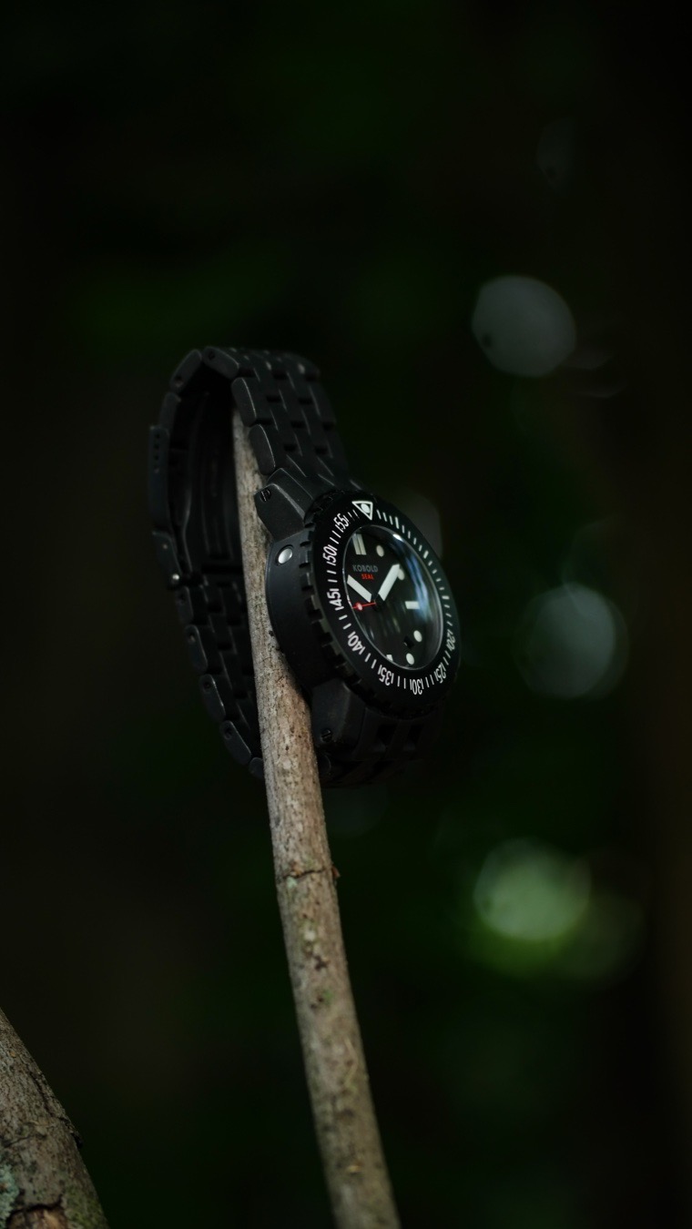 The Kobold Tactical Seal is widely considered one of the toughest mechanical tool watches ever made because it was engineered from the ground up as an indestructible wrist fortress, intentionally stripping away luxury refinement for pure field utility.
Originally launched in 2004 with unique design input from the late actor James Gandolfini, this timepiece earned a cult following among military operators and extreme divers due to its unapologetic, over-engineered resilience.The watch achieves its legendary status through several highly specialized, combat-ready construction choices:
Built Like a Wrist VaultMassive Case Architecture:
Built around the famous Kobold Soarway Case, the watch features an imposing 43.5mm diameter and a massive 17.5mm thickness, providing an expansive physical shield of metal around the internal movement.
Dual-Layer Shock Defense: Beyond standard movement protection, it integrates a proprietary, secondary Shock Absorption System (SAS) built directly into the case architecture to isolate the Swiss mechanical movement from severe impacts and heavy vibrations.
Anti-Magnetic Iron Core: To ensure reliable operation near electronic warfare gear or heavy machinery, a soft-iron inner case completely blankets the movement, creating a formidable shield against intense magnetic fields.
Deep-Sea Hydrostatics: Equipped with a thick, domed sapphire crystal, a secure screw-down crown, and an integrated helium escape valve, it carries an immense 1,000-meter (3,300 feet) depth rating.
Fail-Safe Lug Anchors: Standard spring bars are completely abandoned in favor of heavy-duty, interlocking screw-locked lug bars, guaranteeing the watch cannot be ripped from your wrist during intense physical activity.
A brutally heavy stainless steel stealthy, aerospace-grade black DLC titanium “Tactical” finish, the Kobold Soarway Diver Seal remains a definitive blueprint for no-nonsense, hard-use watchmaking. Often imitated but never replicated!