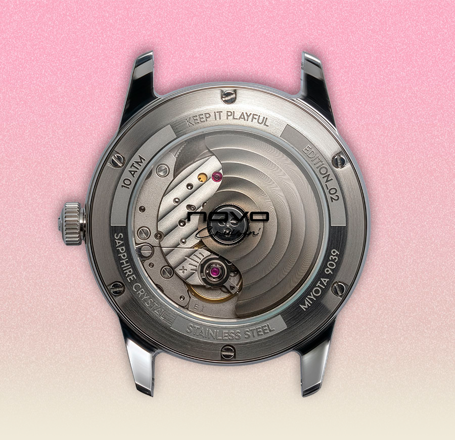 Galo watch case back, stainless steel, showing automatic movement with 'Galo' rotor, red jewels, on a pink background.