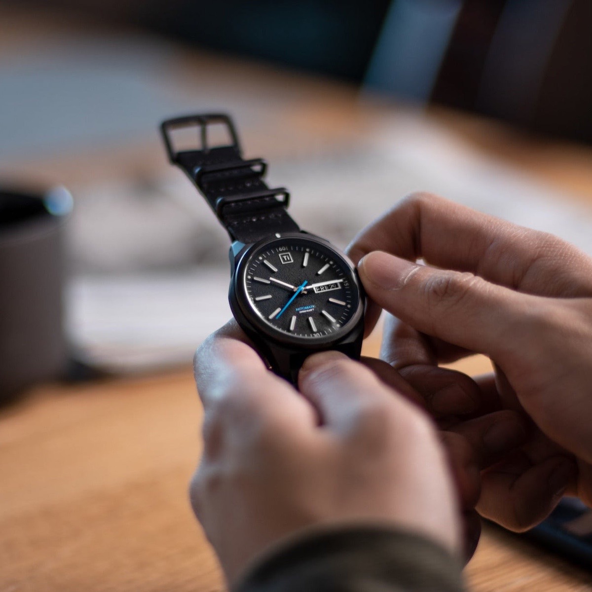 Meet the Ti Field Watch — a collaboration between BIGiDESIGN and RZE Watches. This timepiece is crafted from pure Grade 2 titanium for a durable yet feather-light feel.
At its heart beats the reliable SII NH36A automatic movement, featuring a hand-windable, hacking mechanism and a 41-hour power reserve. The dial is lightly textured, with raised hour markers filled with Swiss Super-LumiNova blue lume for excellent visibility in any light. A clear sapphire case back lets you admire the movement’s precision in motion. The double-dome AR sapphire crystal, screw-down crown, and 200M/660FT water resistance make this a reliable companion for any condition. The simplified rotating bezel adds utility for everyday timing and task management.