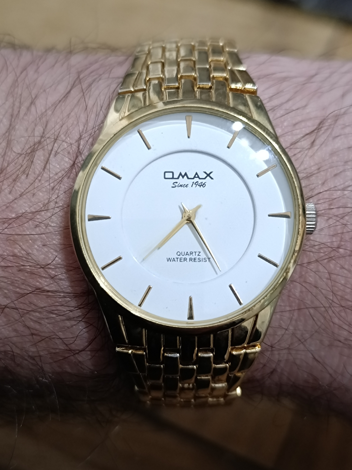 Swiss Omax Quartz Watch with japane movement and assembled in China. Strange combination.
This watch is..... I don't know what to say, really. 
It came together in a lot that I've bought a few years back. I like this thing. It's simple. Looks good. A cheap and accessible watch for all. 