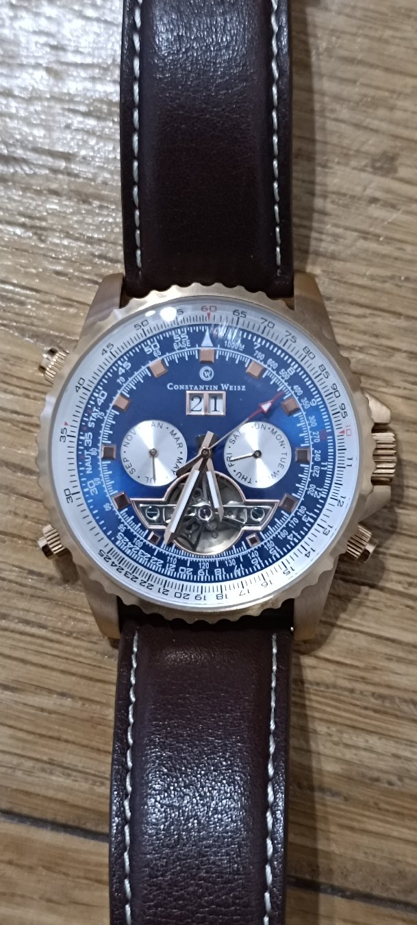 Morning everyone 
Taking a closer look at the Constantin Weisz Automatic (Ref: 18A394CW)! Featuring a stunning navy blue dial, full calendar complications, a slide-rule bezel, and an open-heart aperture showing off its 29-jewel automatic movement. 

What do you think of this piece? Let me know in the comments!

Don't forget to Like & Subscribe for more daily watch content! ⌚✨

#watches #watchtok #horology #constantinweisz #automaticwatch #watchcollector #arbalexwatches


Specification

Details

Brand

Constantin Weisz

Reference

18A394CW

Movement Type

Mechanical Automatic (Self-Winding)

Movement Origin

PTS Resources / Chinese Automatic Caliber (Finished & cased by Constantin Weisz in Germany)

Jewel Count

29 Jewels

Functions

Hours, Minutes, Central Seconds, Big Date, Day Sub-dial, Month Sub-dial, Slide-Rule Bezel

Dial

Deep Navy Blue with Rose-Gold-Tone Accents & Open-Heart Aperture (at 6 o'clock)

Case Material

Stainless Steel with Rose-Gold-Tone IP Finish

Case Back

Exhibition / Mineral Glass Screwed Case Back

Bezel

Bi-directional Rotating Slide-Rule Bezel (Fluted Outer Edge)

Water Resistance

5 ATM / 50 Meters

Strap / Lug

Dark Brown Genuine Leather with Contrast Stitching
