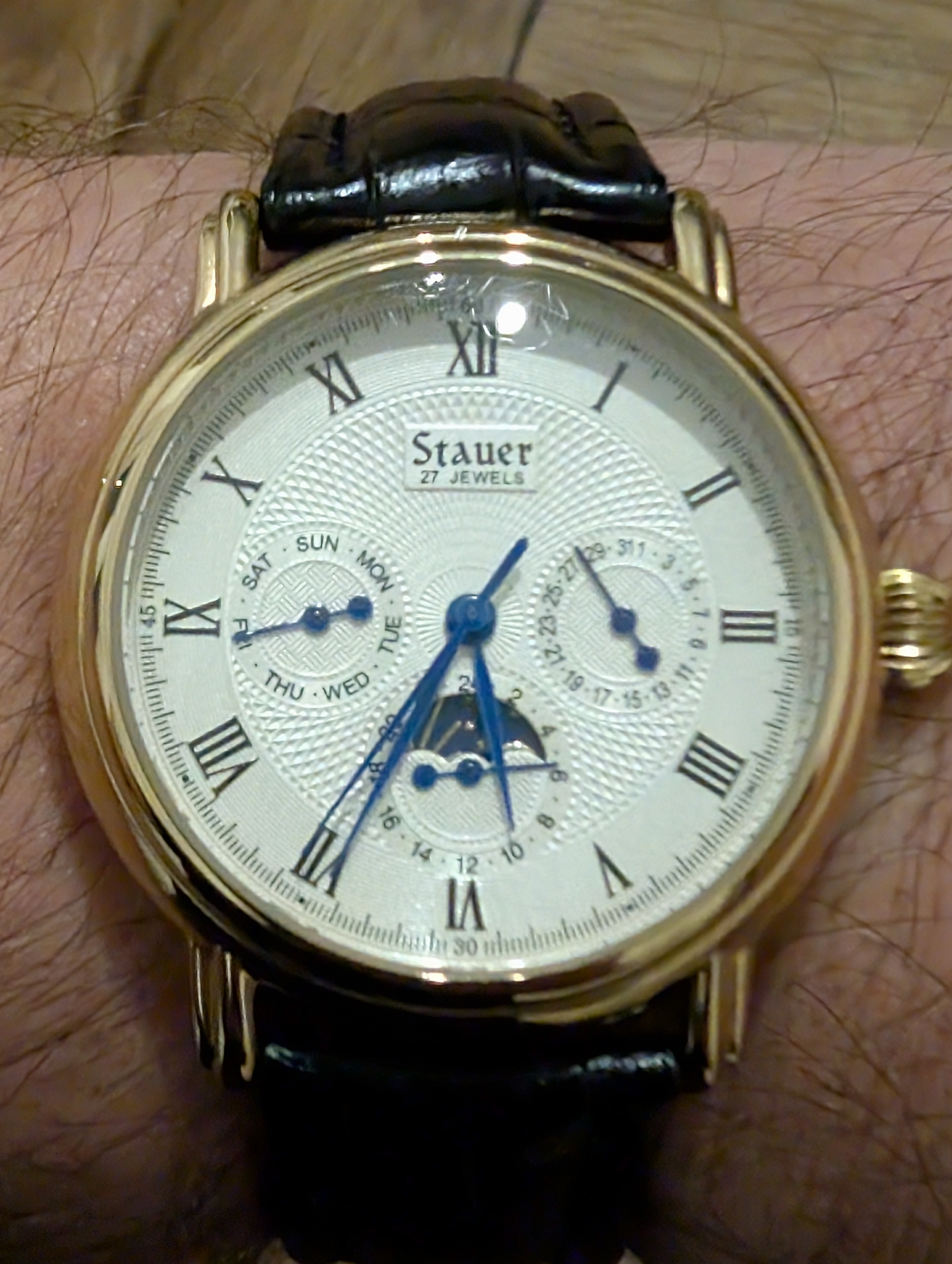 Morning,
Stiff strap? Loud rotor? Sure. But flip this Stauer over and it says "China" right on the back. Unlike brands selling dropshipped parts-bin watches for £500, at least this one gives you classic complications without the fake luxury story.  
