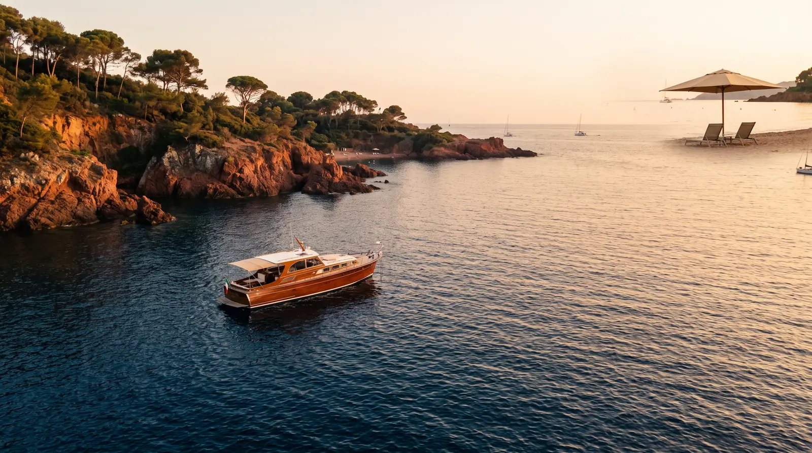 Motor yacht anchored off the red rocks of the French Riviera