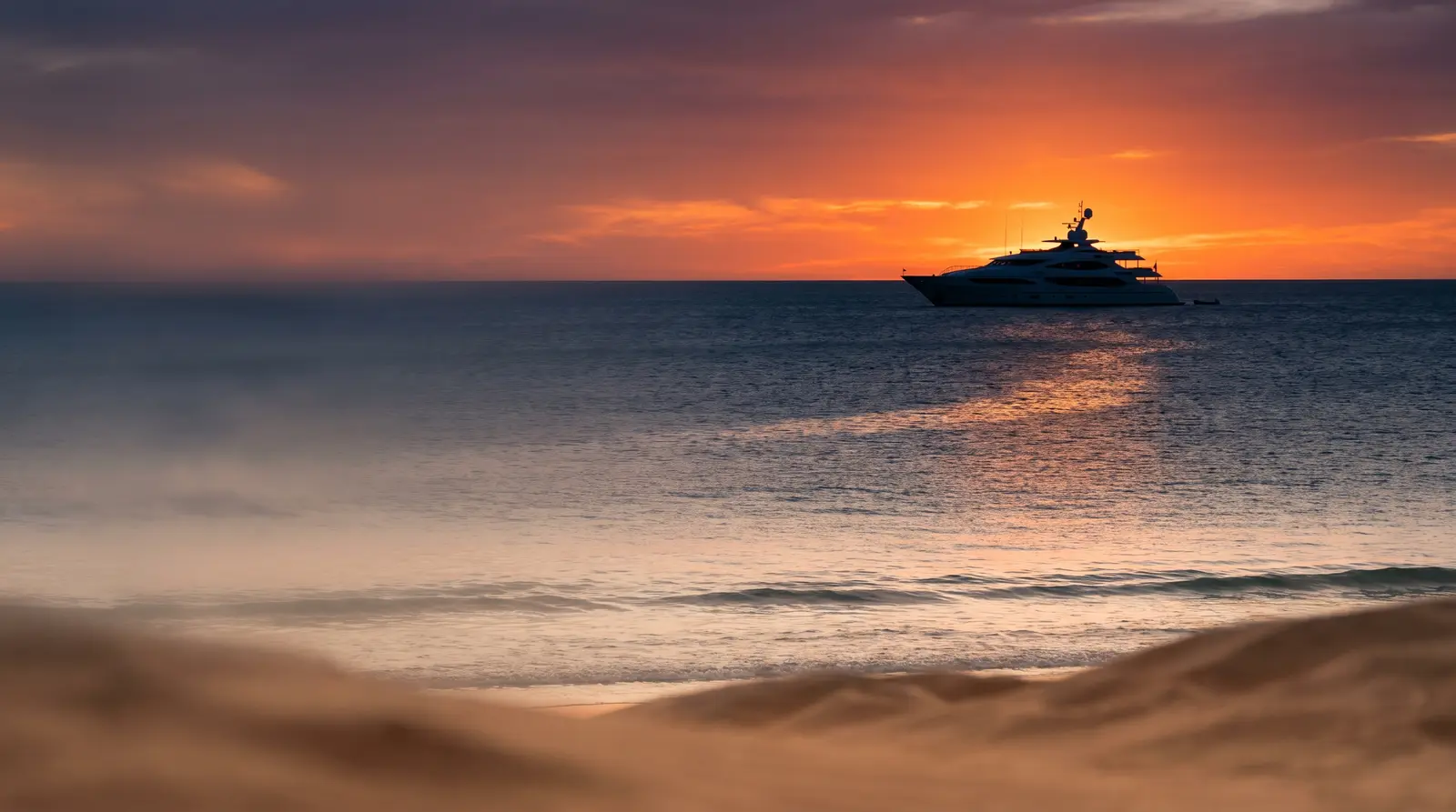 Yacht at sunset off Cable Beach