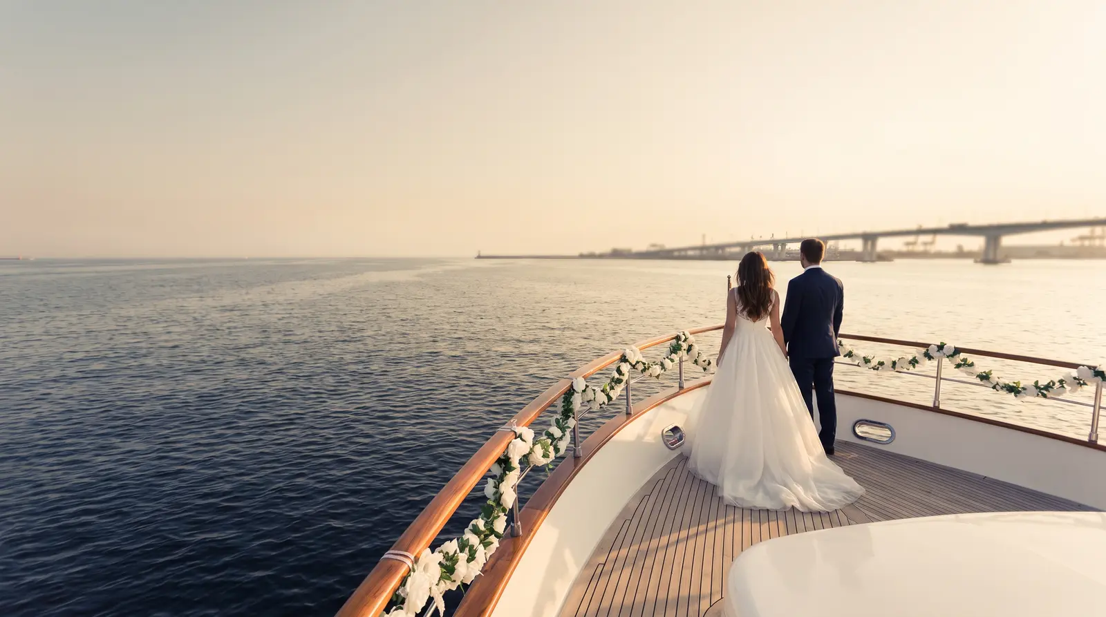 Couple on the foredeck of a yacht at sunset
