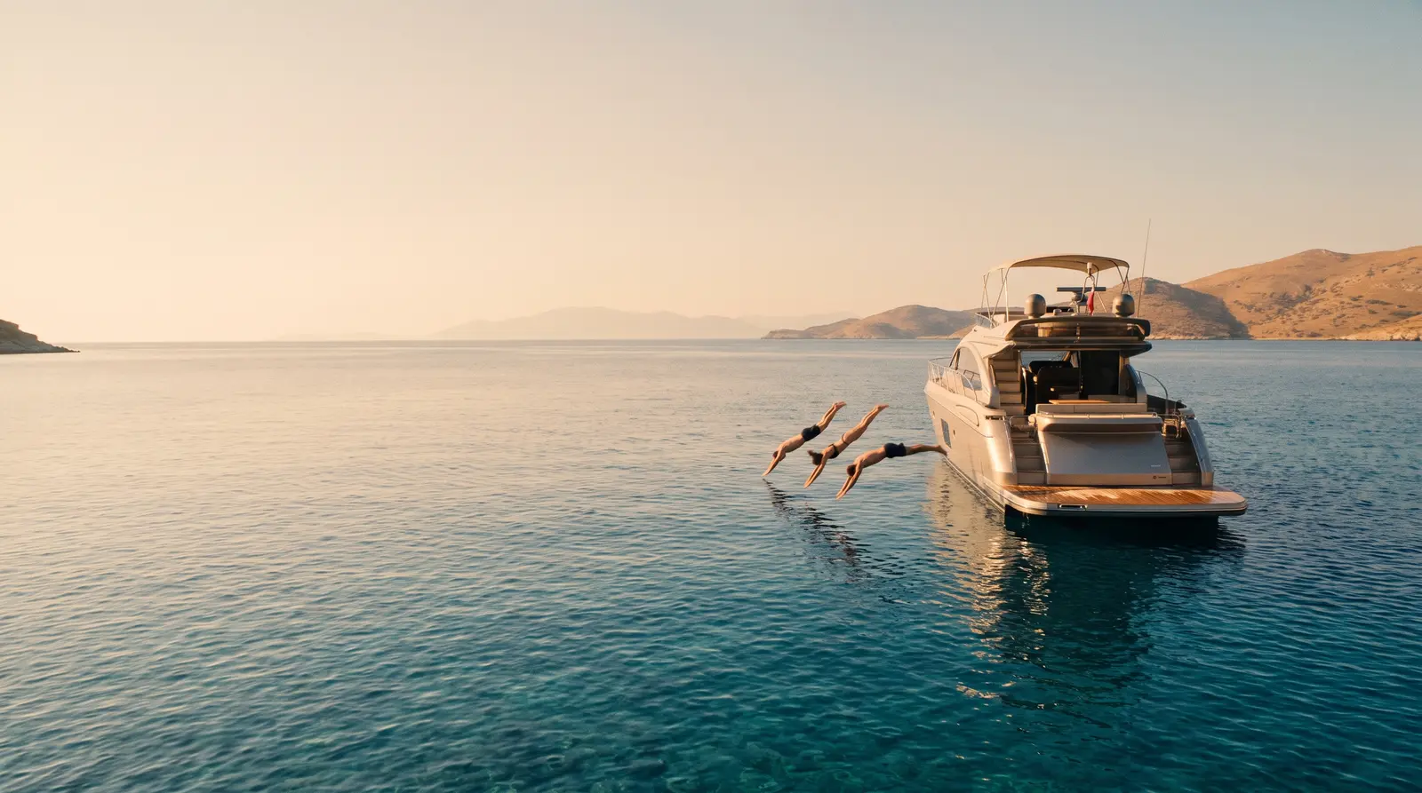 Friends jumping from a yacht swim platform