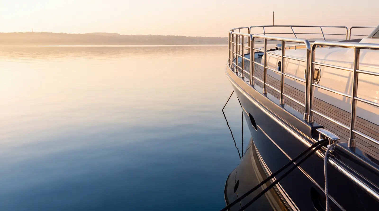 Superyacht bow at a marina at dawn