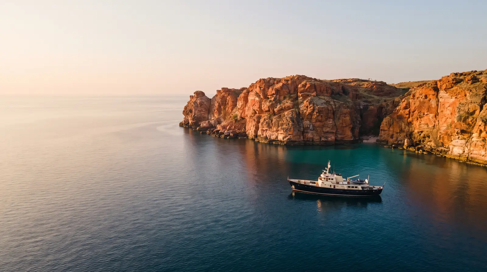 Expedition yacht beneath Kimberley cliffs