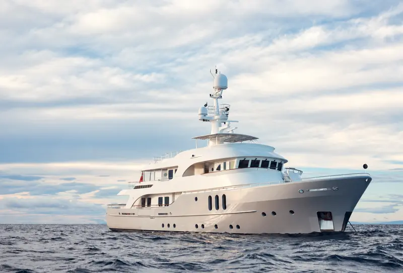 Yacht sailing beneath a cloudy sky