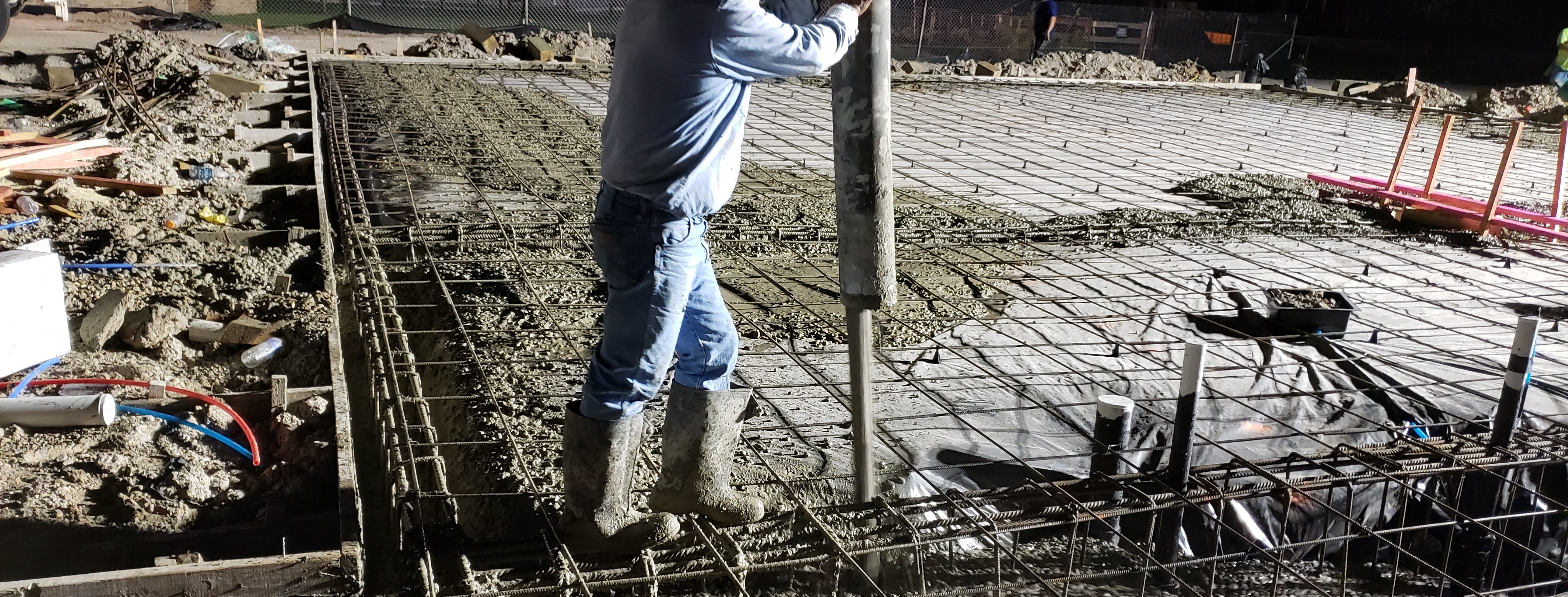 VeraBuilt team overlayed on an image of them working together on a construction project
