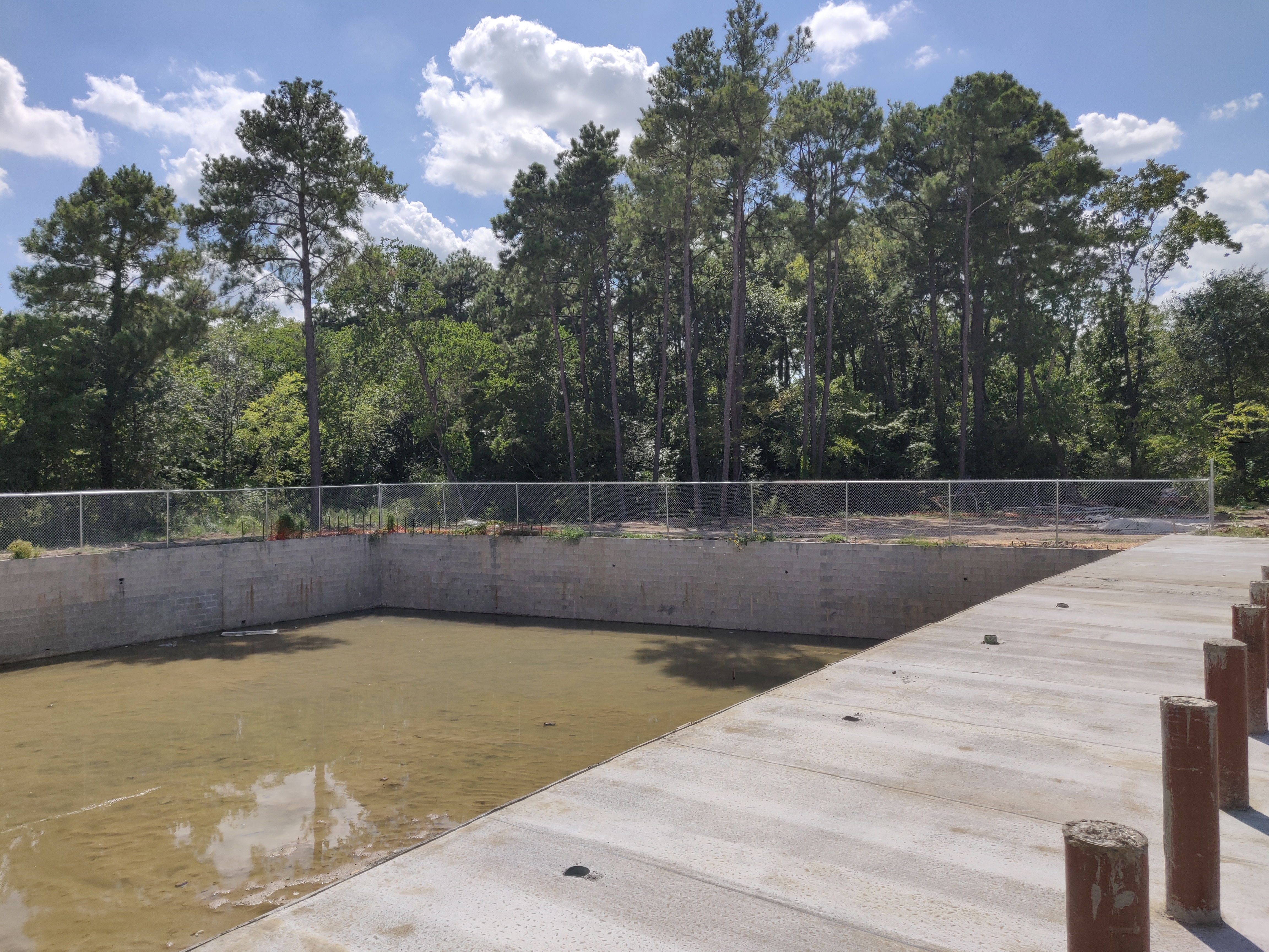 Rainwater detention pond for flood control at commercial site