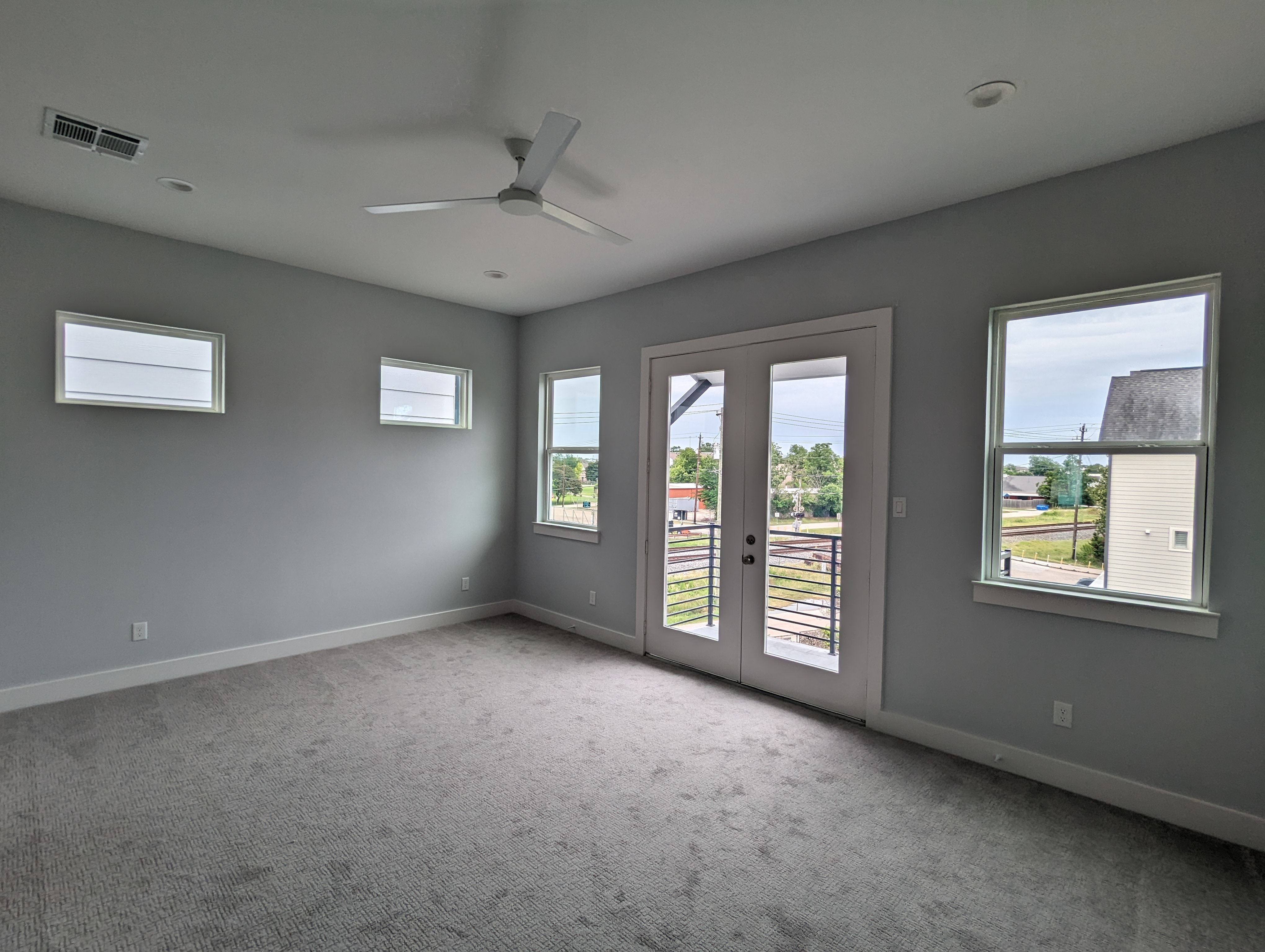 Master bedroom with private balcony in modern townhome