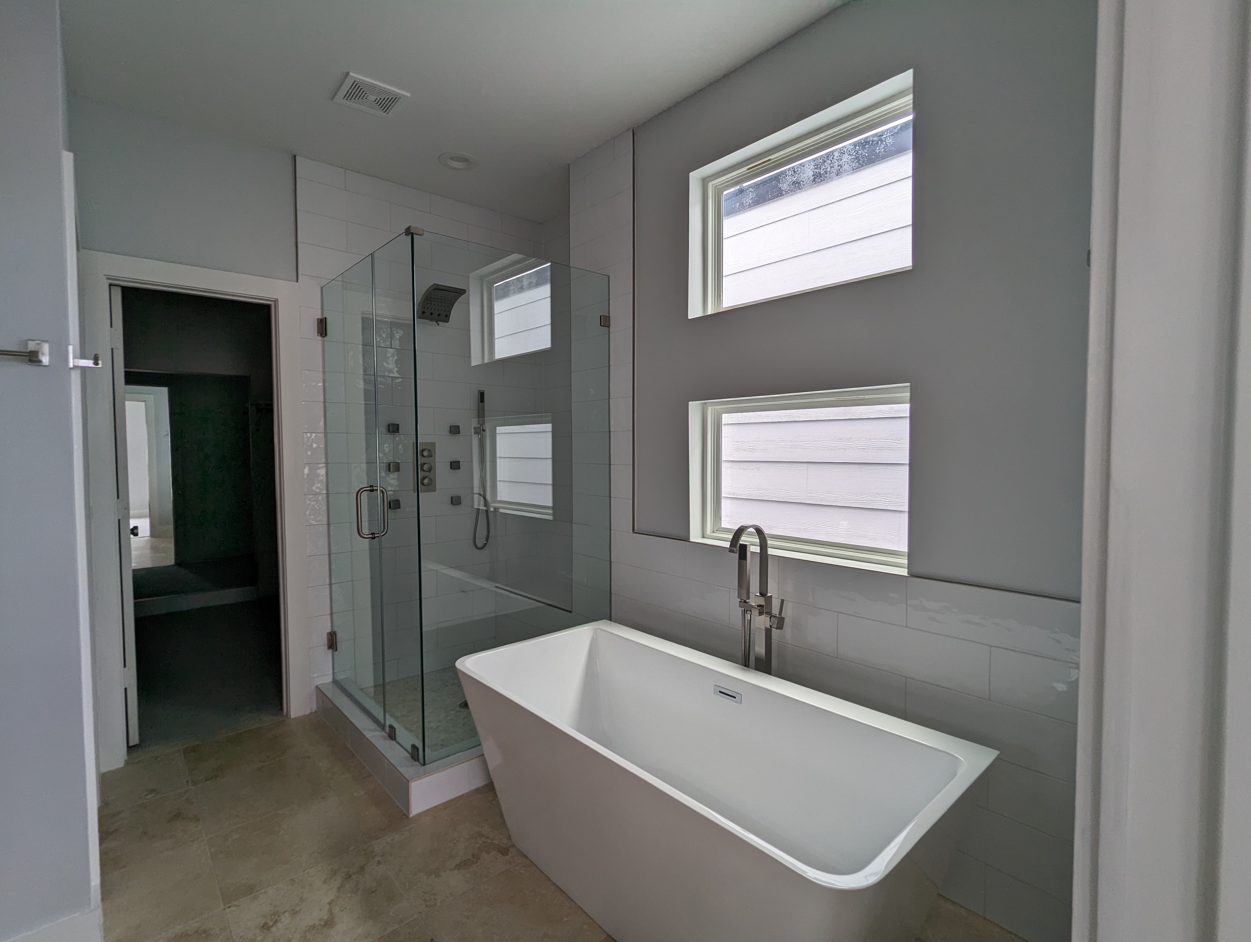 Main bathroom with freestanding bathtub in modern townhome