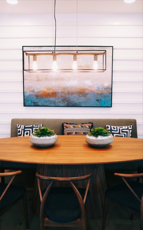 A stylish kitchen with dark cabinets and a dining area.