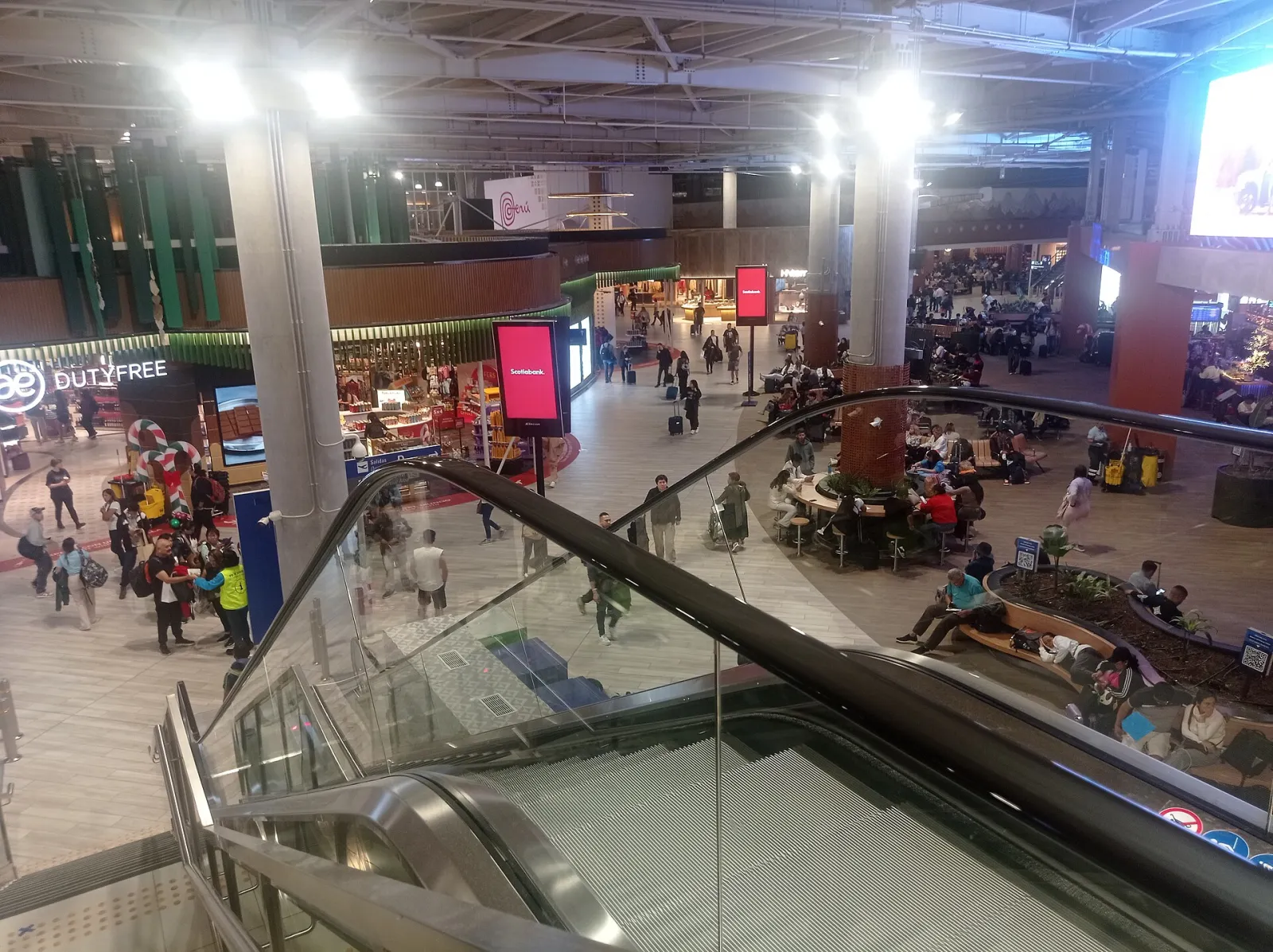 Travelers walking through the departures hall of Lima's Jorge Chávez airport in 2025