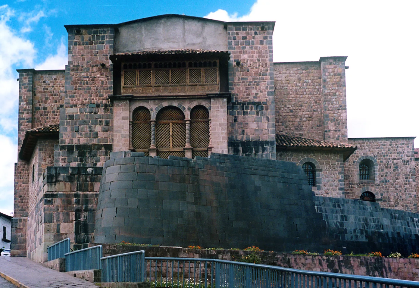 Curved Inca stone wall of Qorikancha in Cusco under the colonial convent