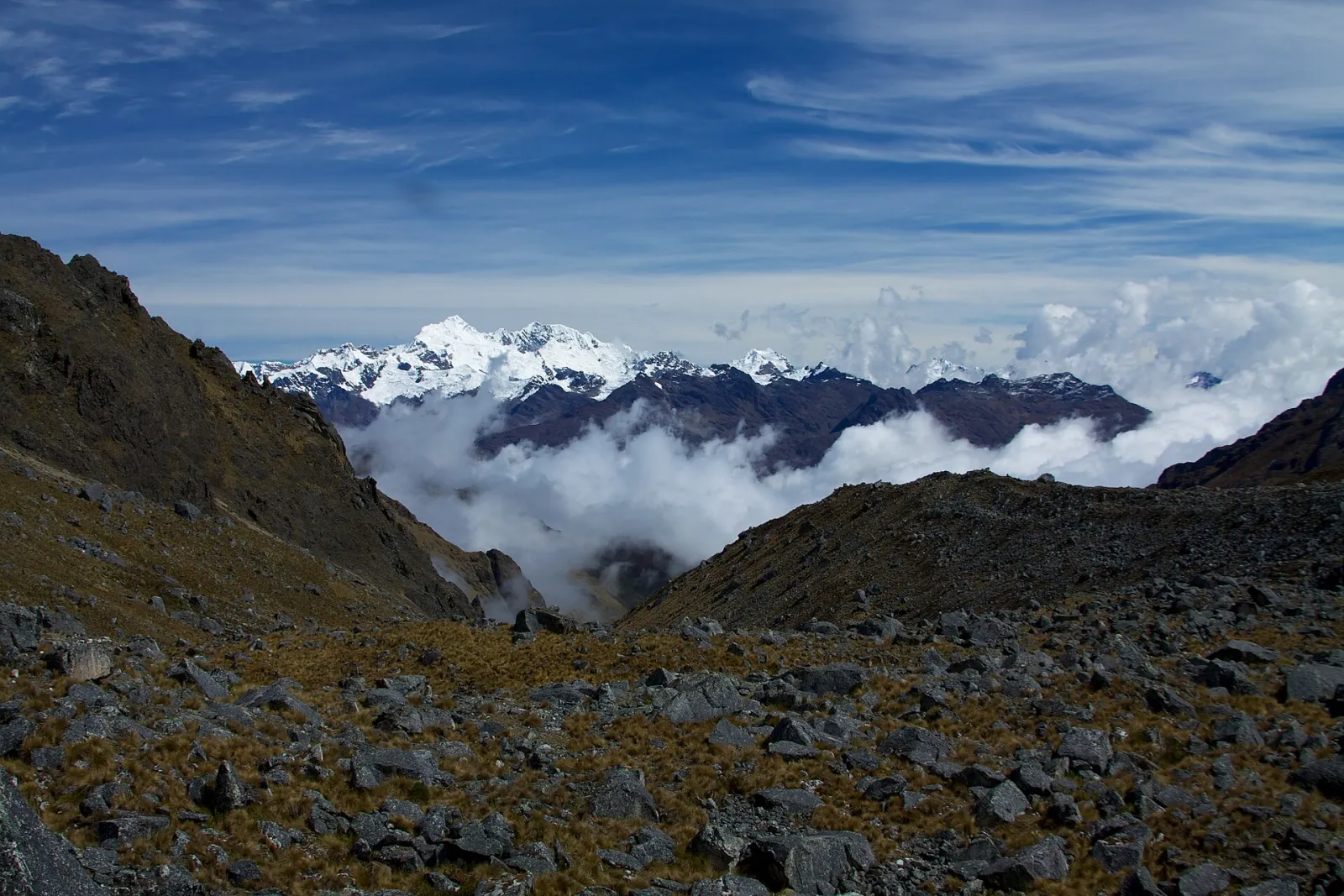 Mountains and mist-filled valleys seen from the far side of the Salkantay Pass
