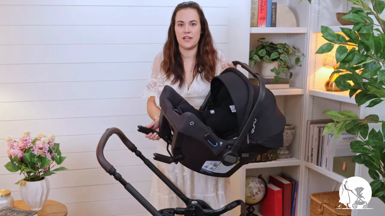 Clear side profile of Nuna PIPA URBN infant car seat installed on Nuna TRIV LX stroller showing canopy and frame