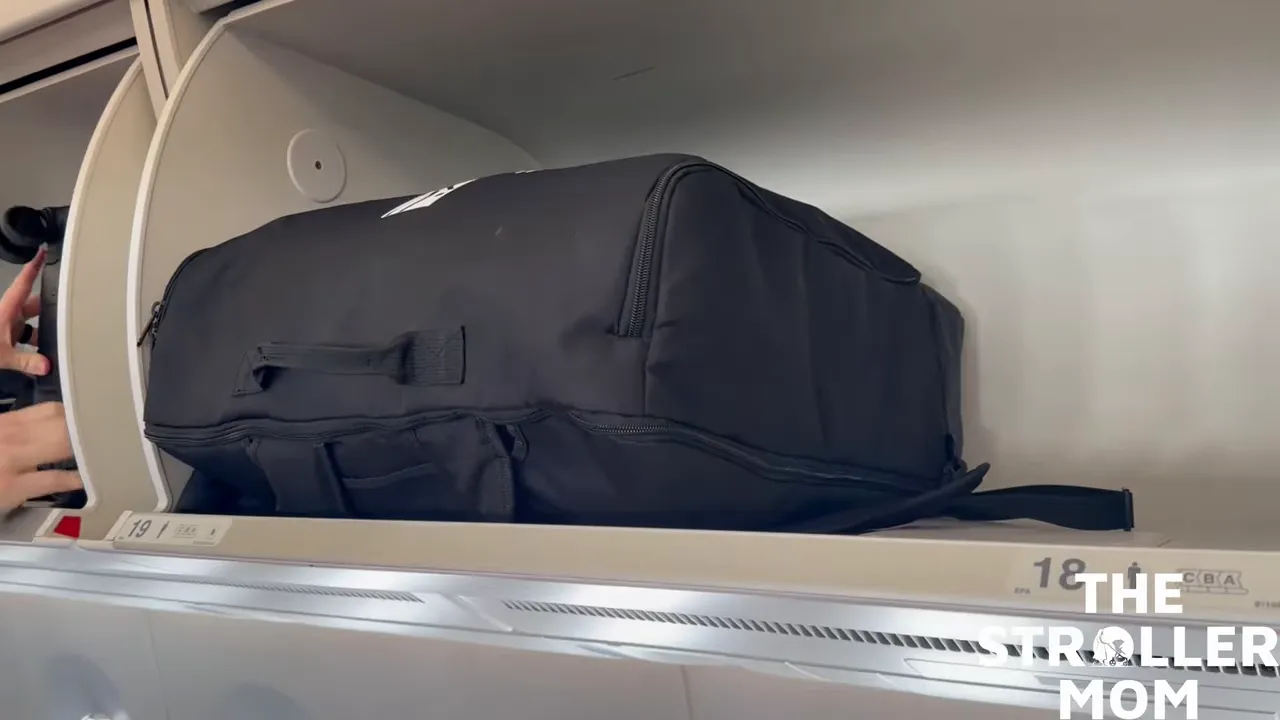 Stroller inside padded travel bag in the overhead bin of an airplane