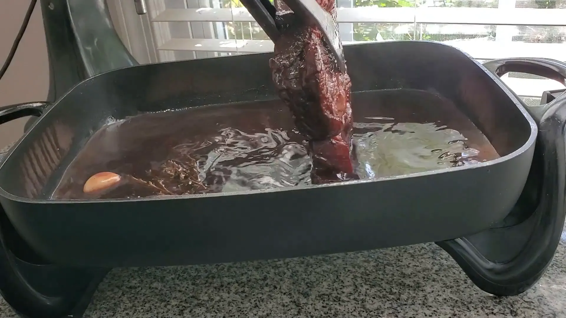 Adding vegetables to the pot.