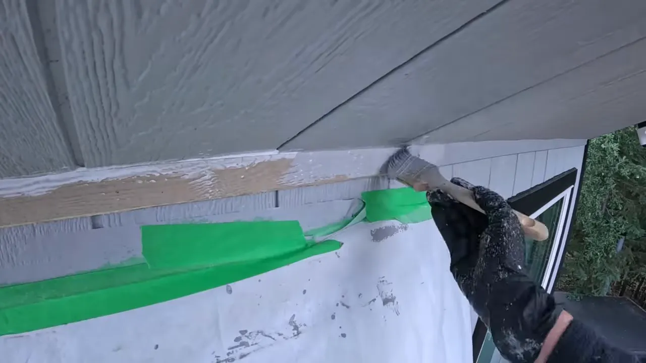 Off grid life - close view of painted soffit and trim edge with green masking tape