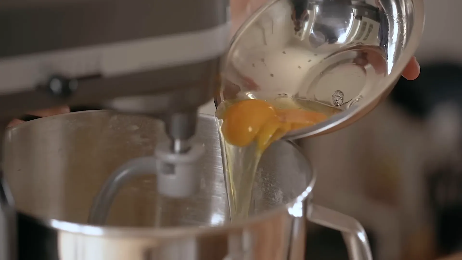 Adding yeast mixture and eggs to the dry ingredients.
