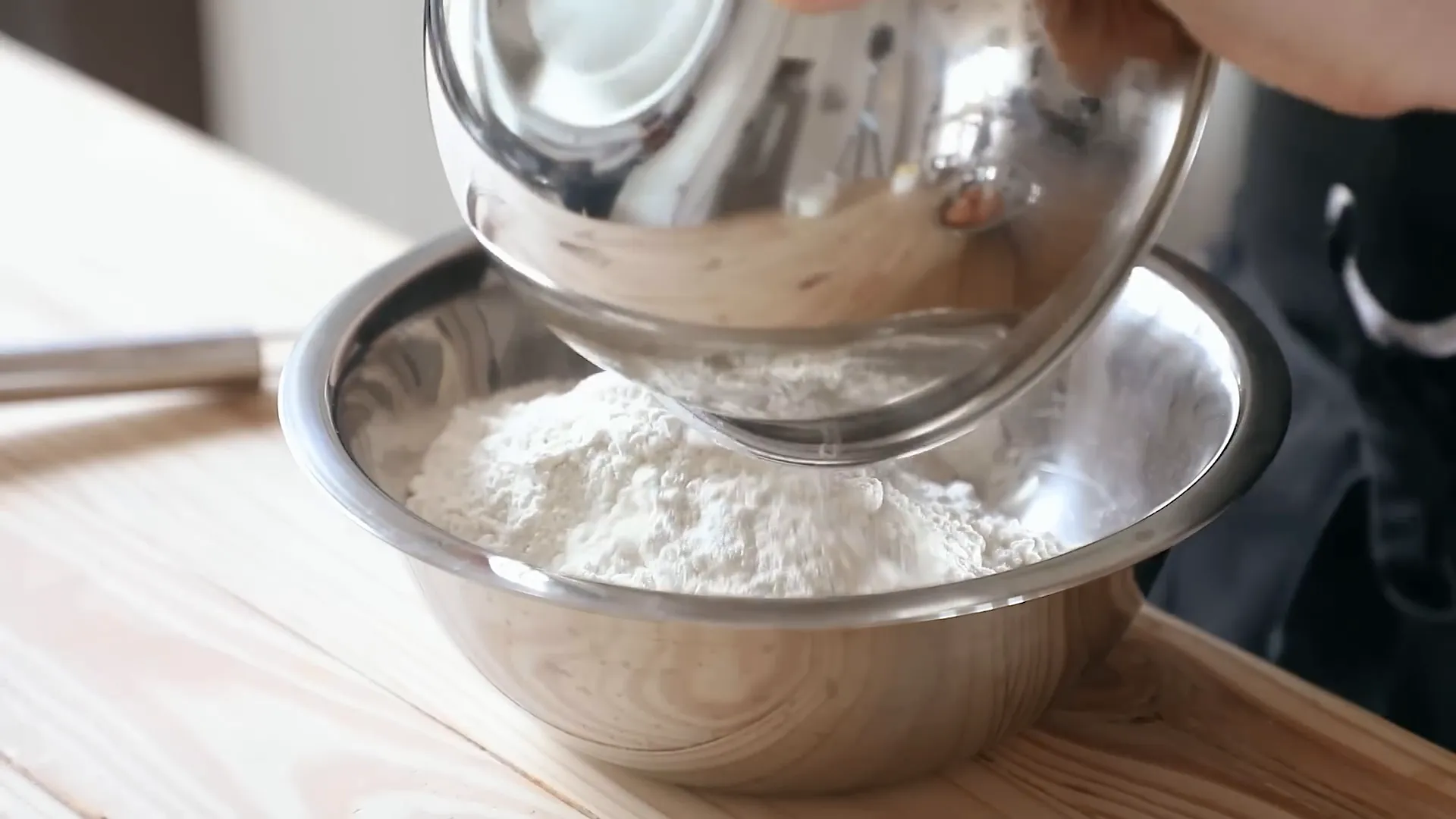 Adding flour, sugar, and salt to the bowl.