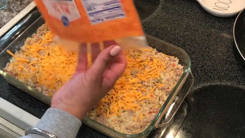Topping the casserole with cheese