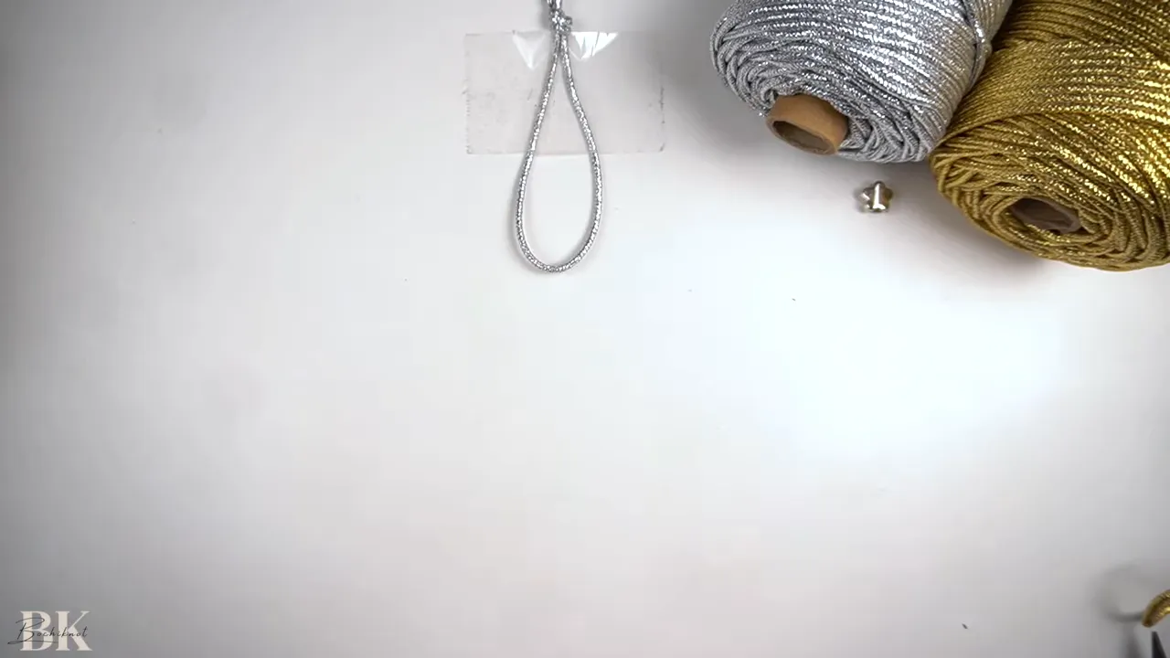 Completed overhand knot forming a looped macrame handle